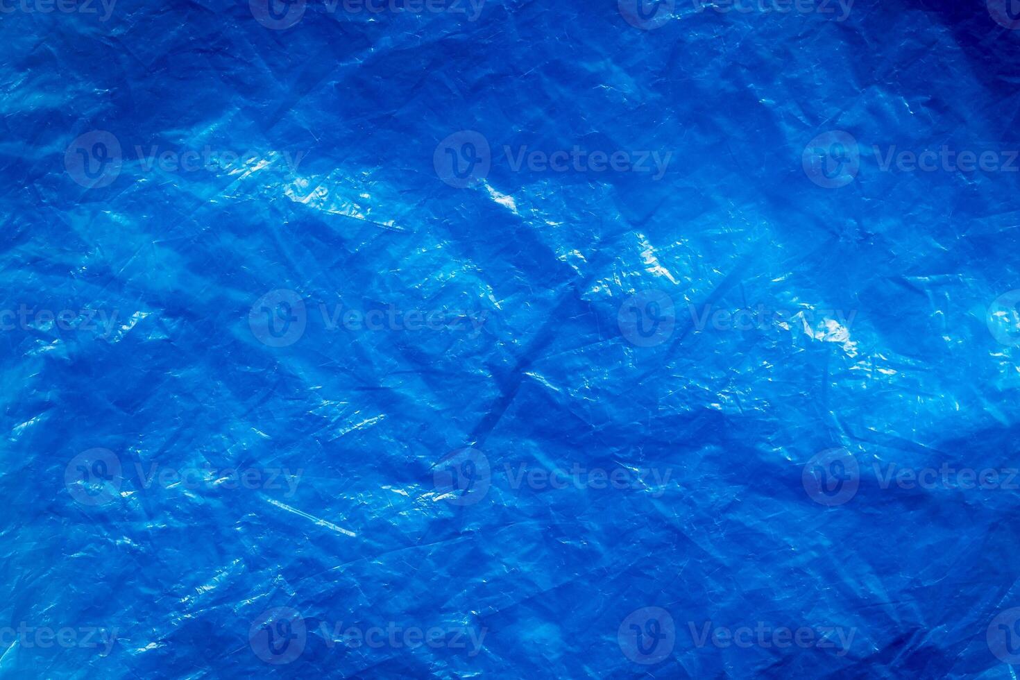 Texture of crumpled blue plastic trash bag. Abstract background for design. photo
