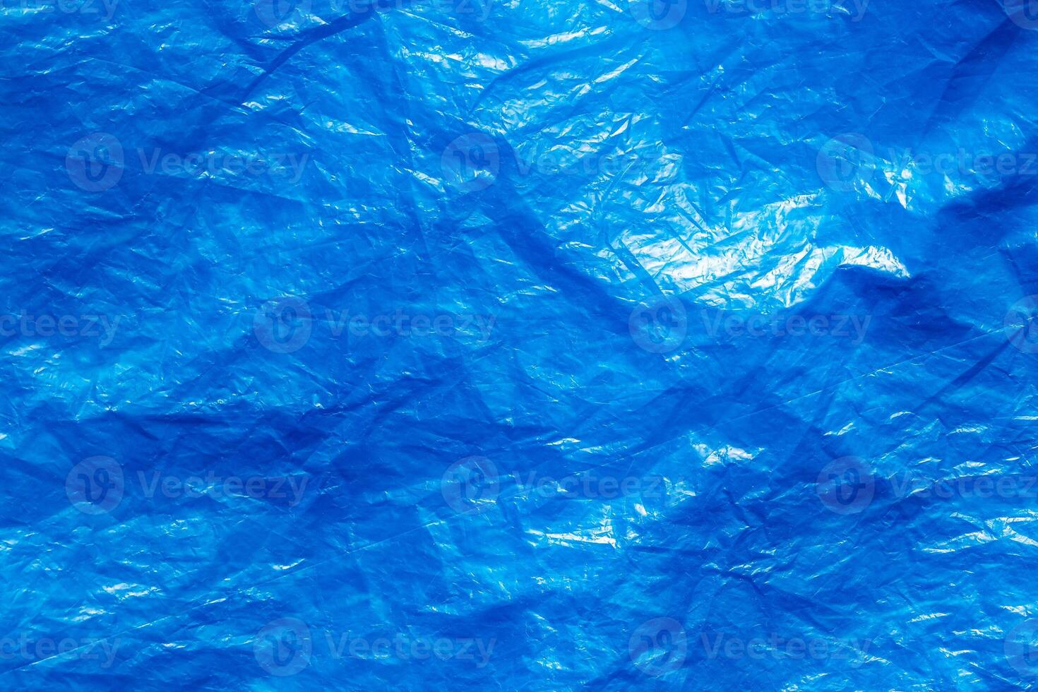 Texture of crumpled blue plastic trash bag. Abstract background for design. photo