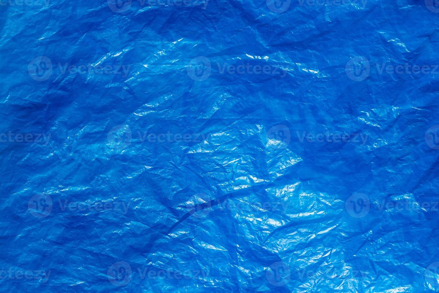 Texture of crumpled blue plastic trash bag. Abstract background for design. photo