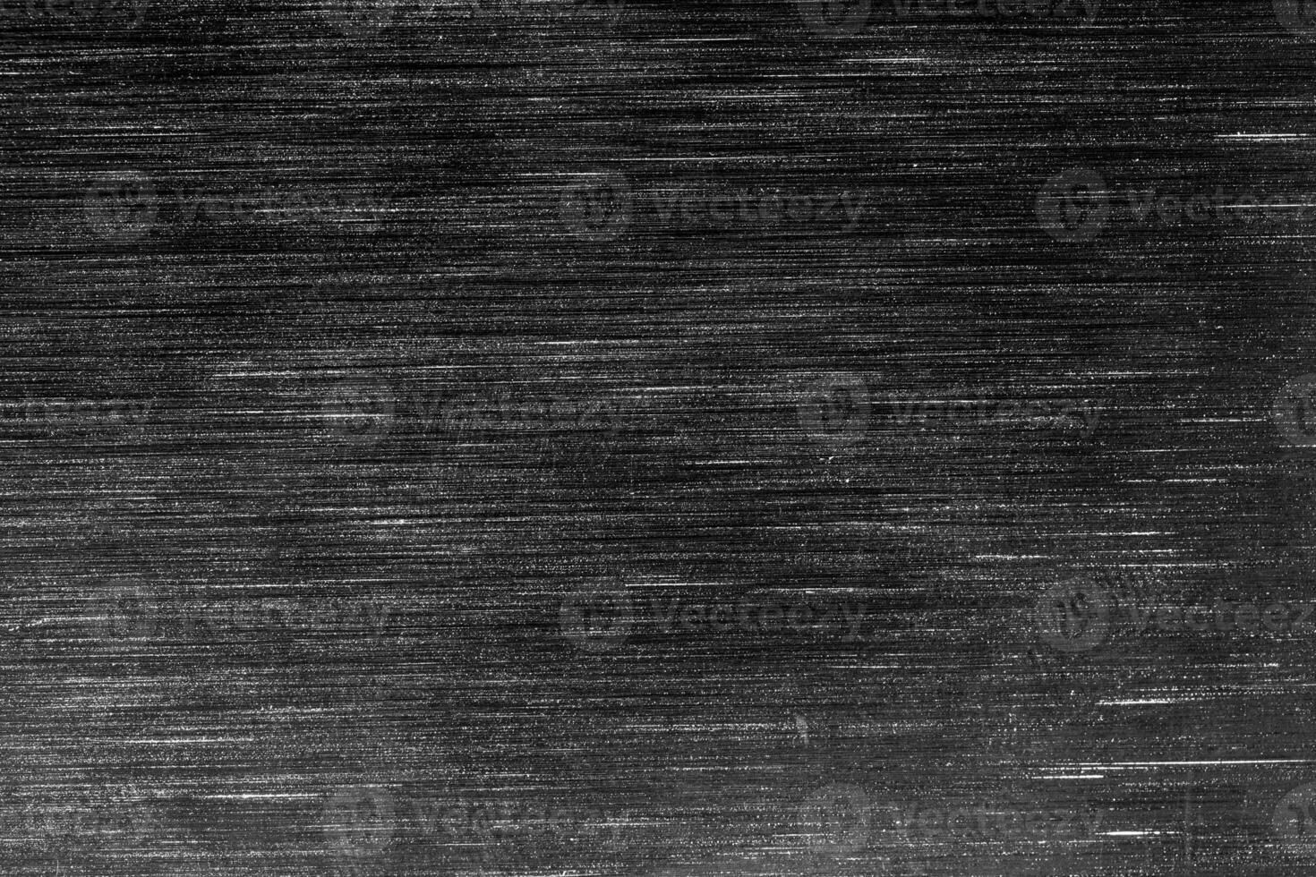Black metal texture with white scratches. Abstract noise black background overlay. photo