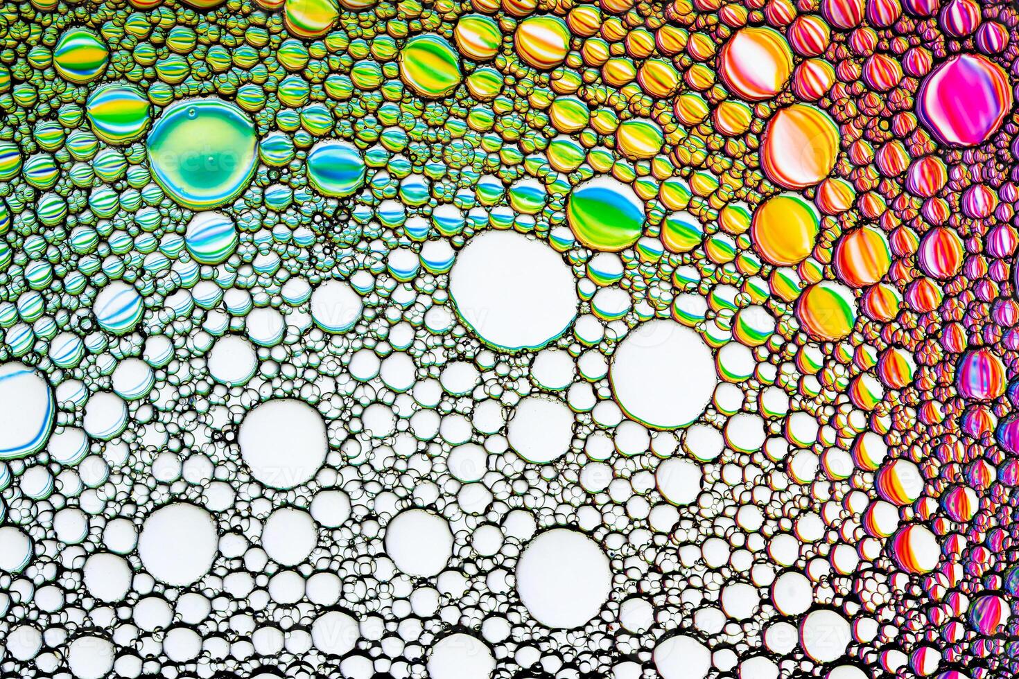 Colorful drops of oil on the water. Circles and ovals. Abstract bright background for design. photo