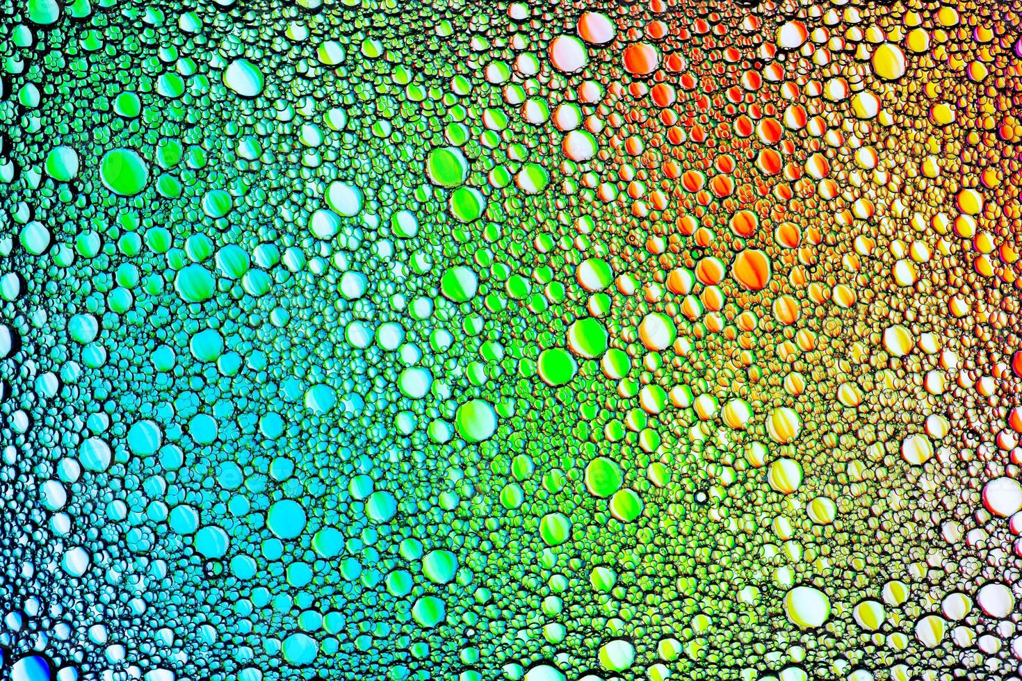 Colorful drops of oil on the water. Circles and ovals. Abstract bright backdrop for design. photo