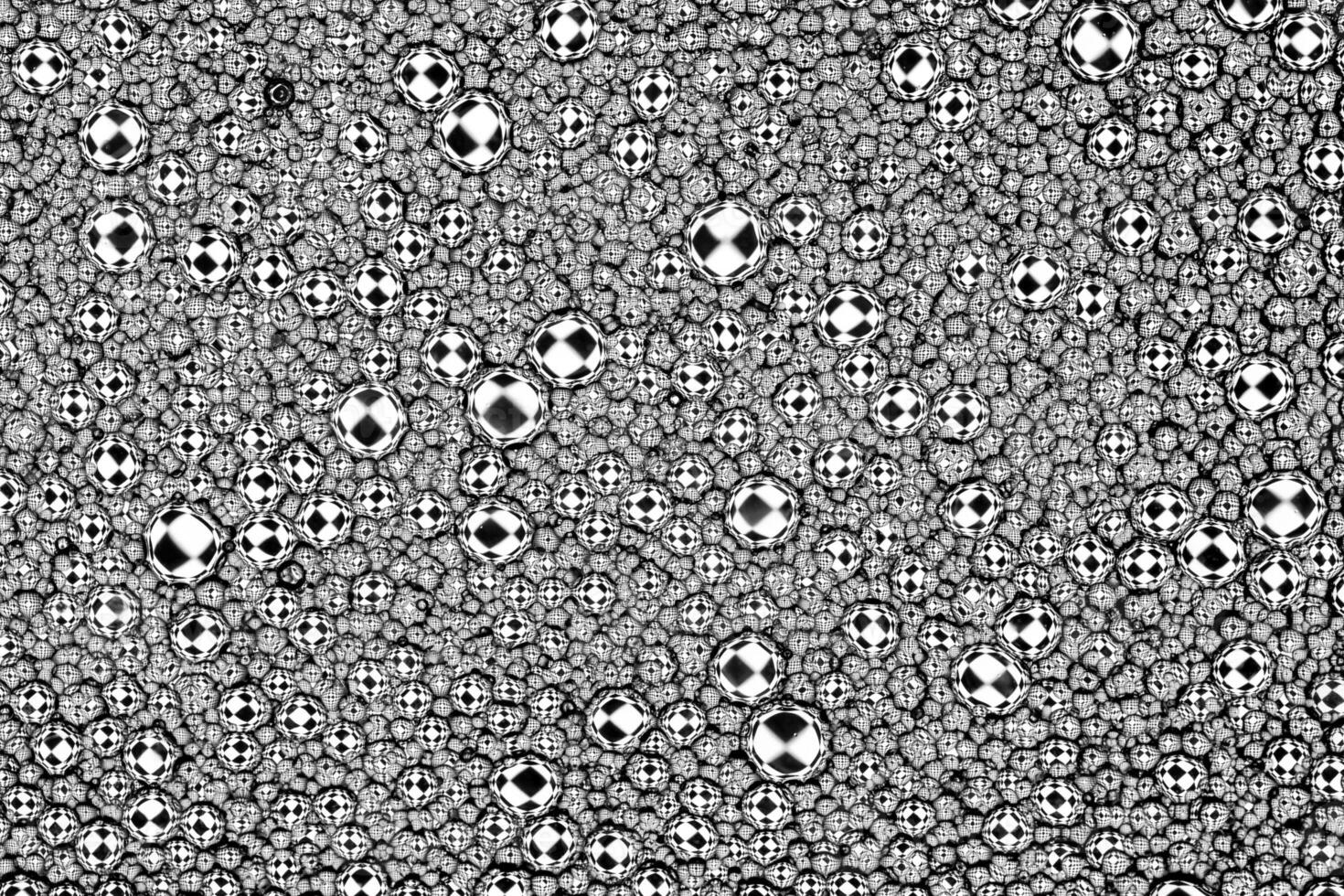 Black and white drops of oil on the water. Circles and ovals. Abstract background for design. photo