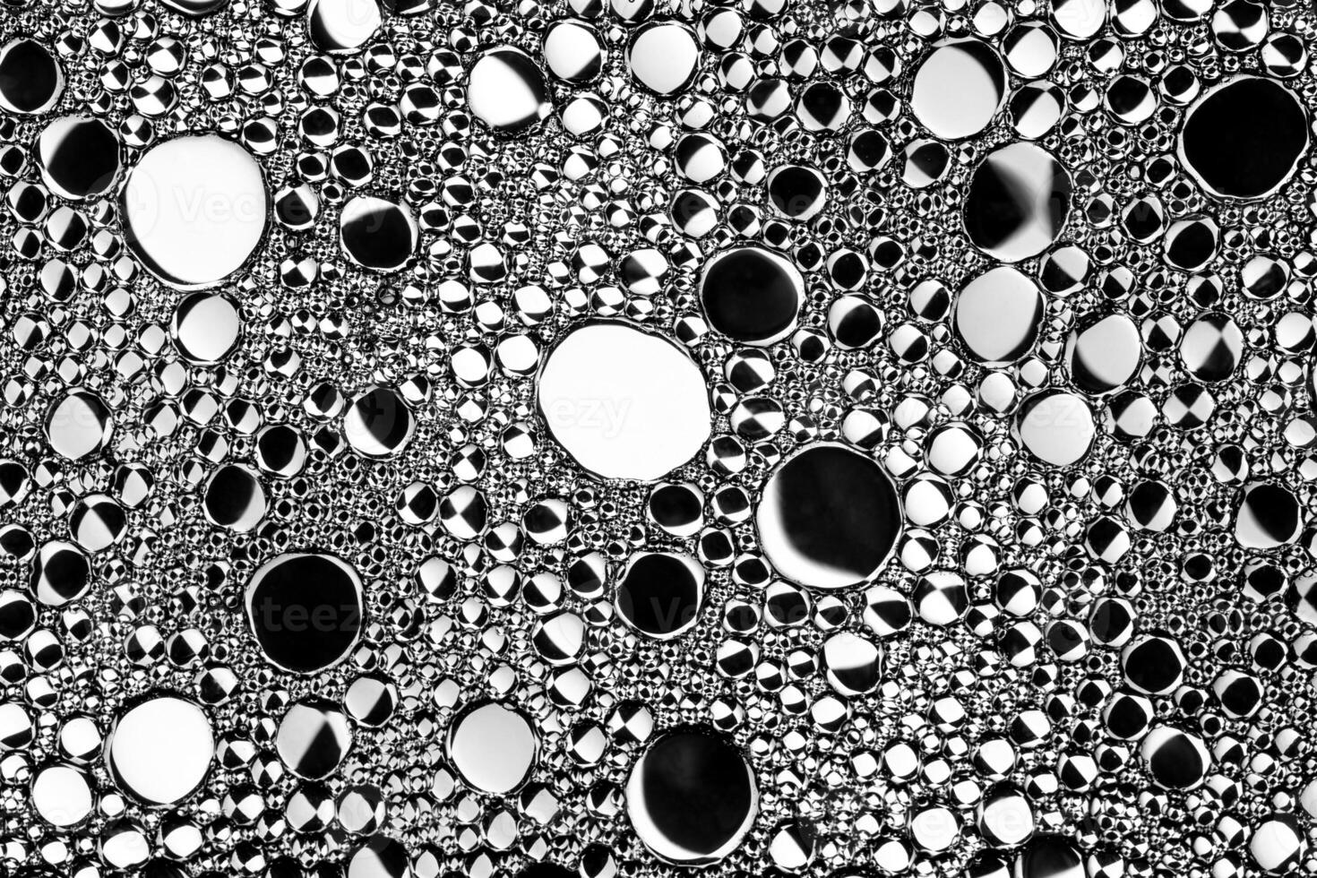 Black and white drops of oil on the water. Circles and ovals. Abstract background for design. photo