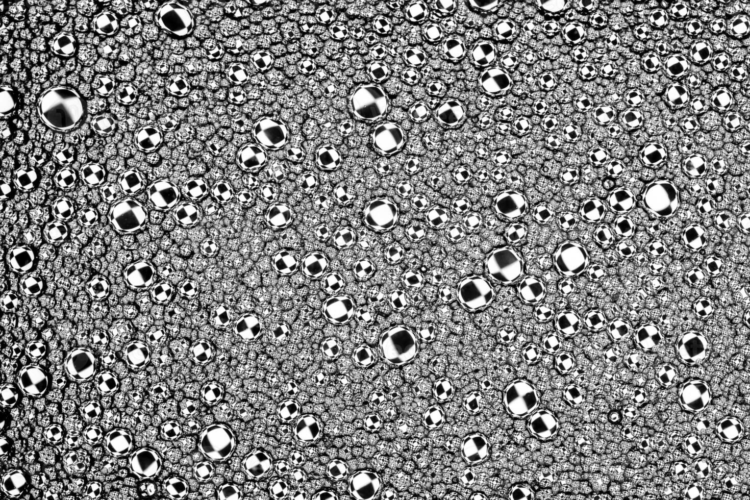 Black and white drops of oil on the water. Circles and ovals. Abstract background for design. photo