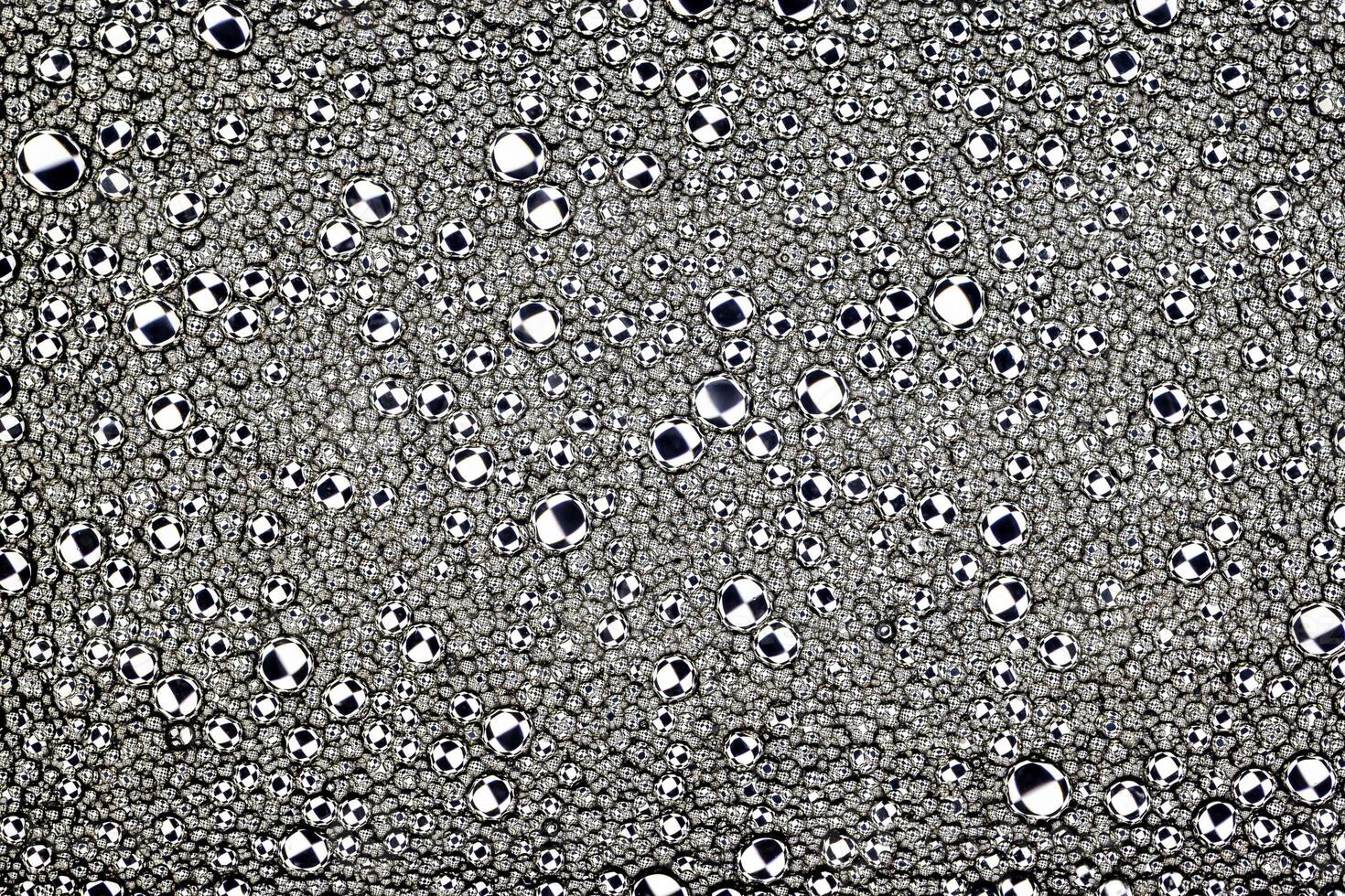 Black and white drops of oil on the water. Circles and ovals. Abstract background for design. photo