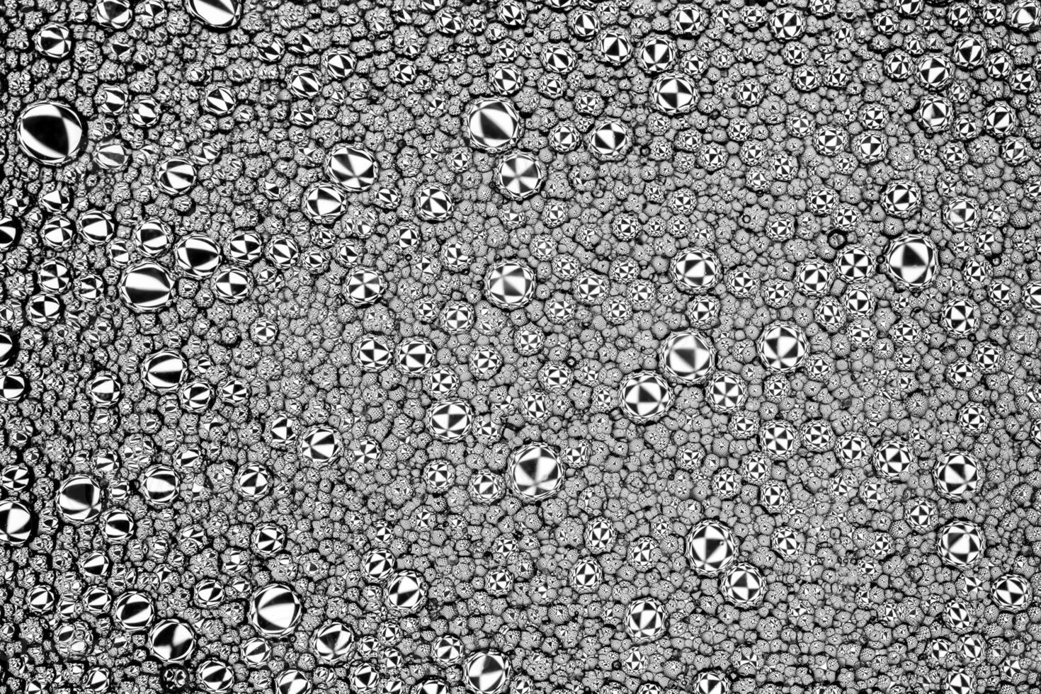 Black and white drops of oil on the water. Circles and ovals. Abstract background for design. photo
