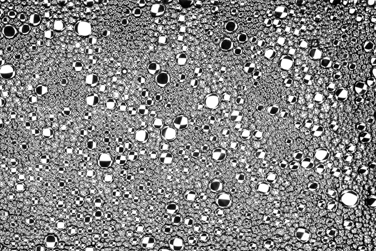 Black and white drops of oil on the water. Circles and ovals. Abstract background for design. photo