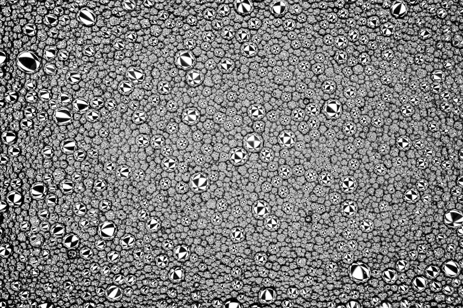 Black and white drops of oil on the water. Circles and ovals. Abstract background for design. photo
