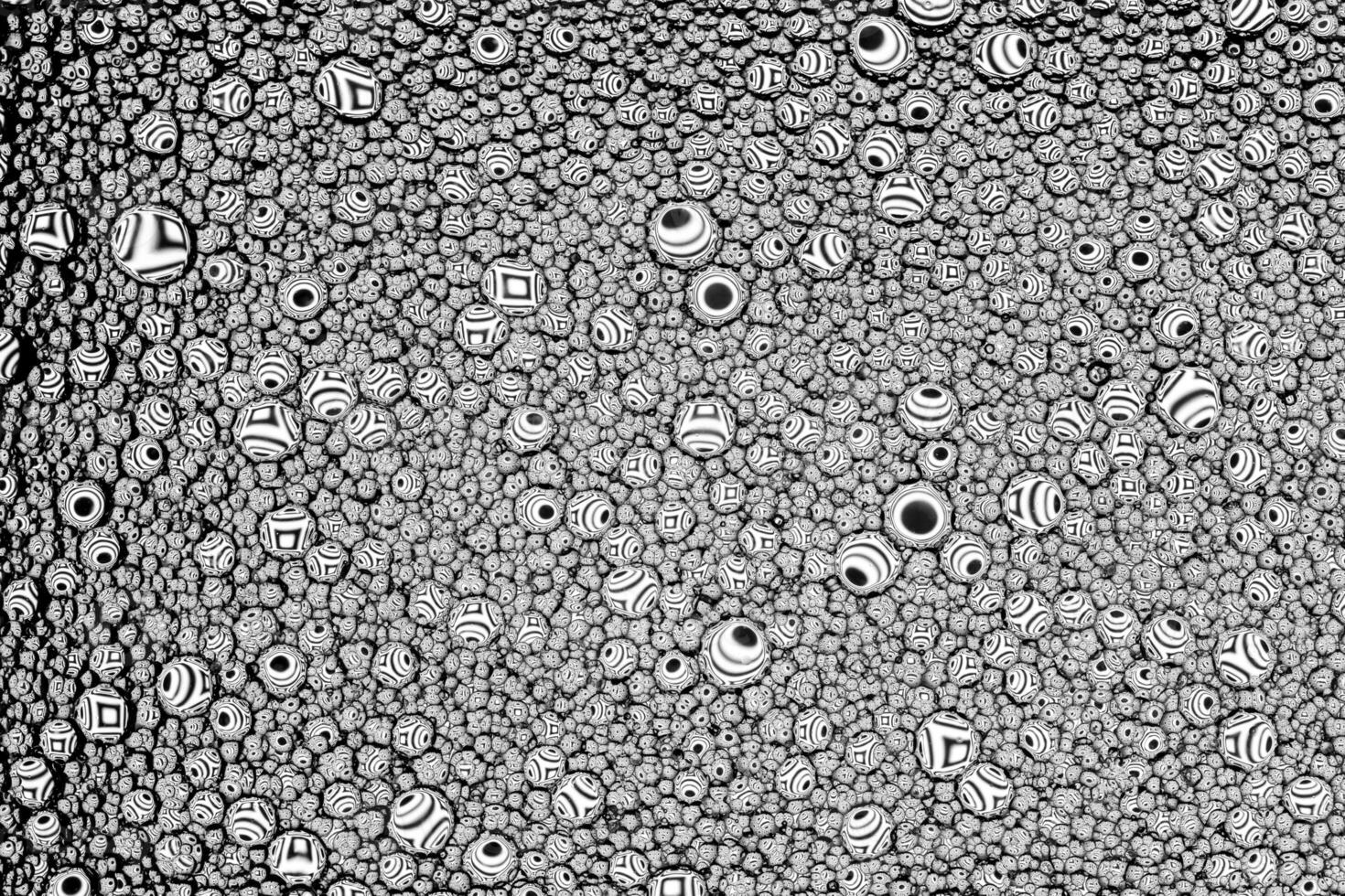 Black and white drops of oil on the water. Circles and ovals. Abstract background for design. photo