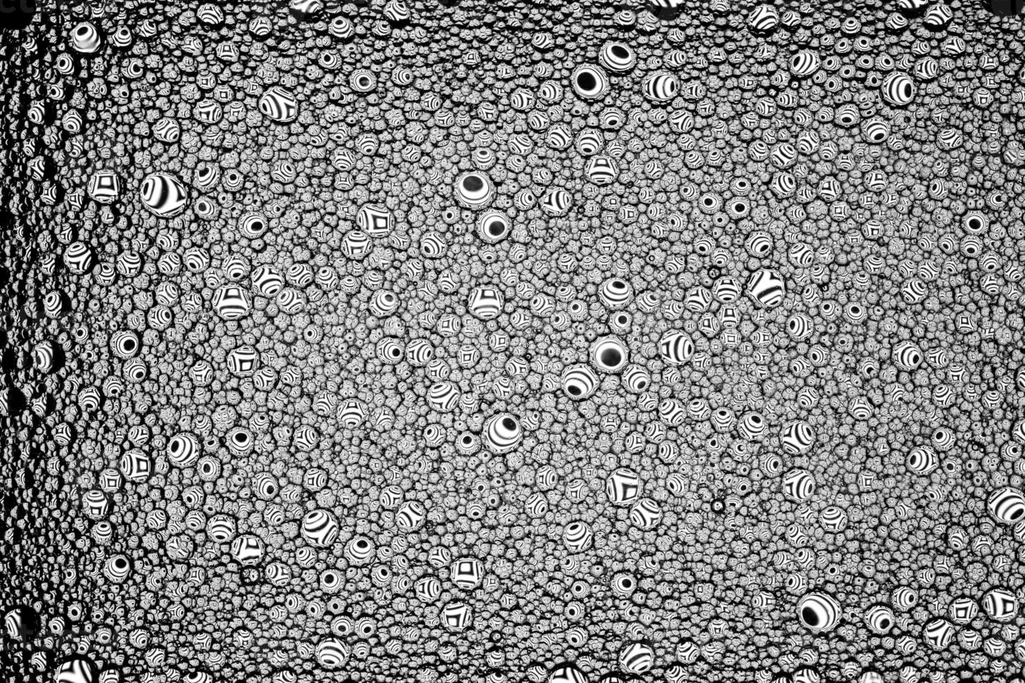 Black and white drops of oil on the water. Circles and ovals. Abstract background for design. photo