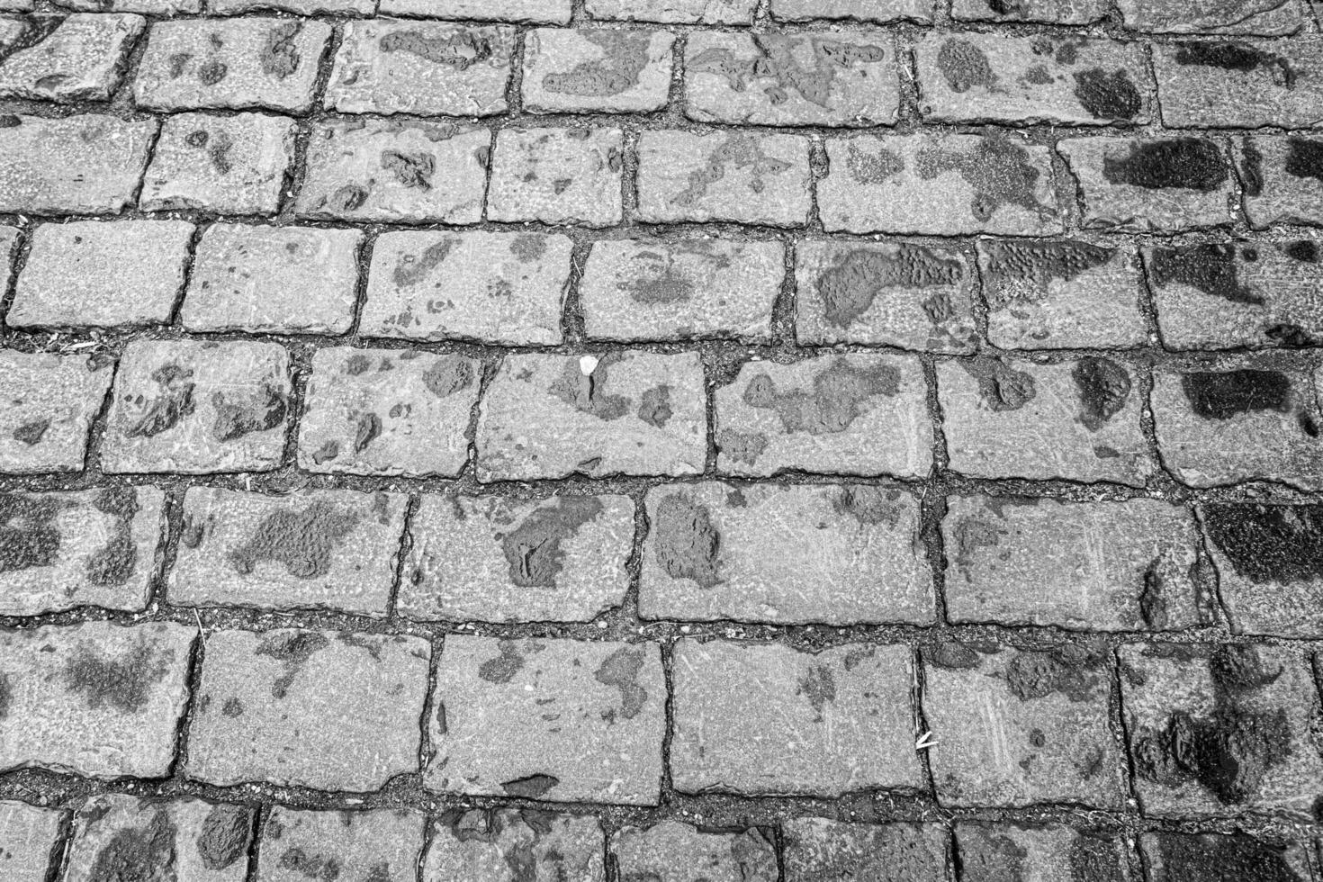 Top view on paving stone road. Old pavement of granite texture. photo