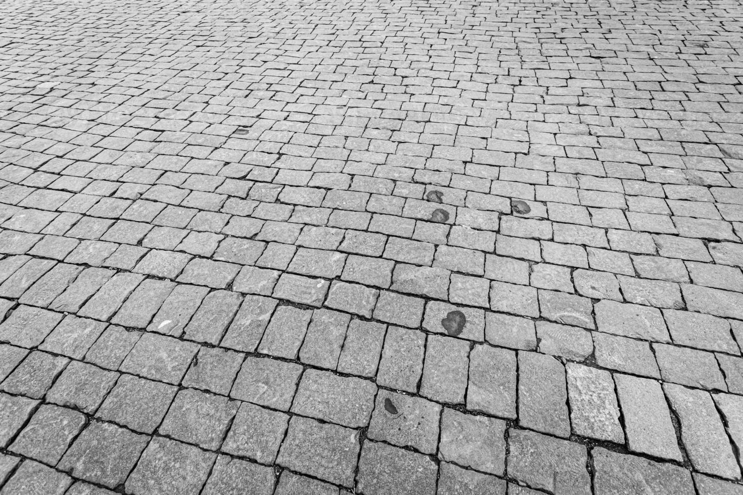 Top view on paving stone road. Old pavement of granite texture. photo