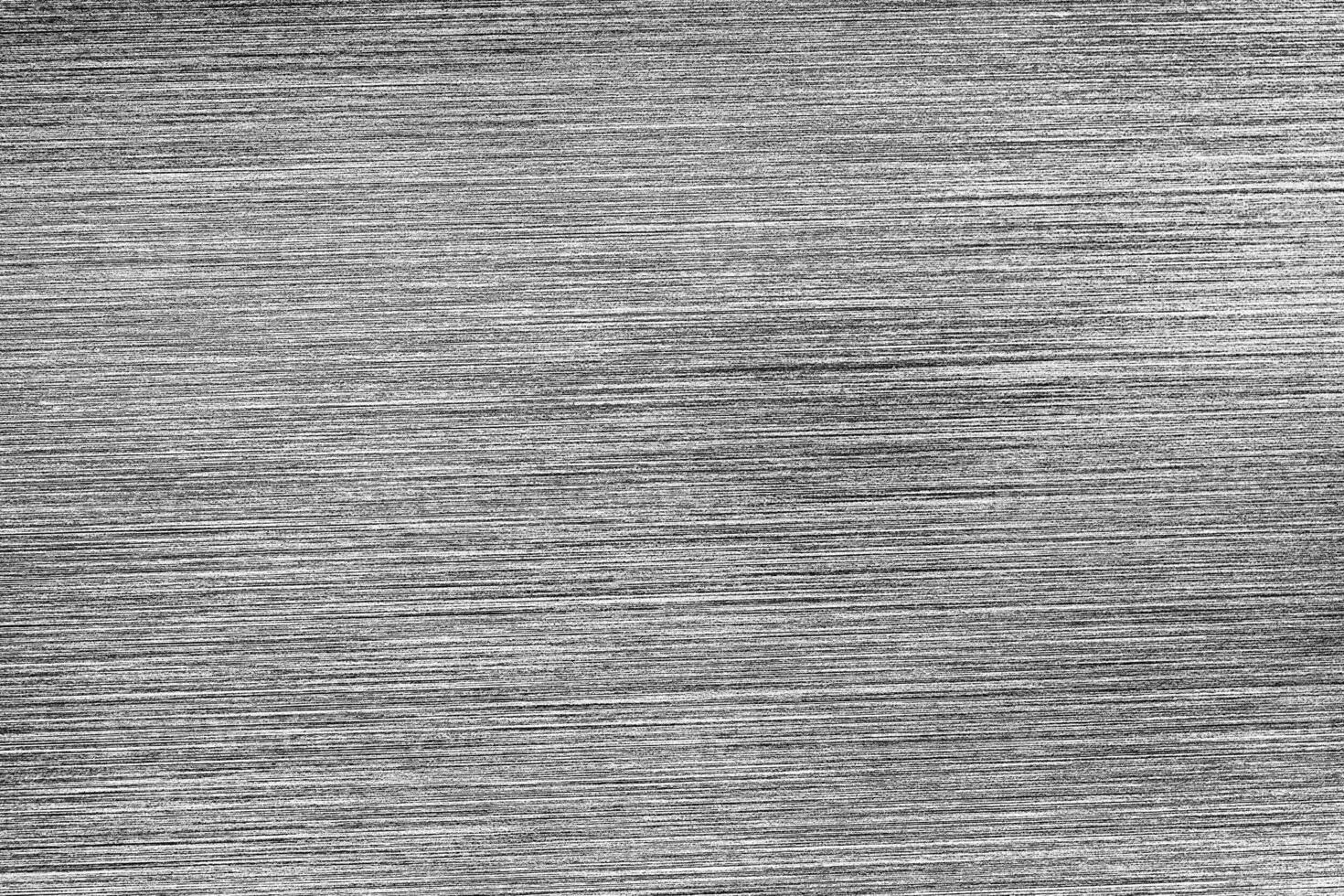 Metal texture with white scratches. Abstract noise black background overlay for design. photo