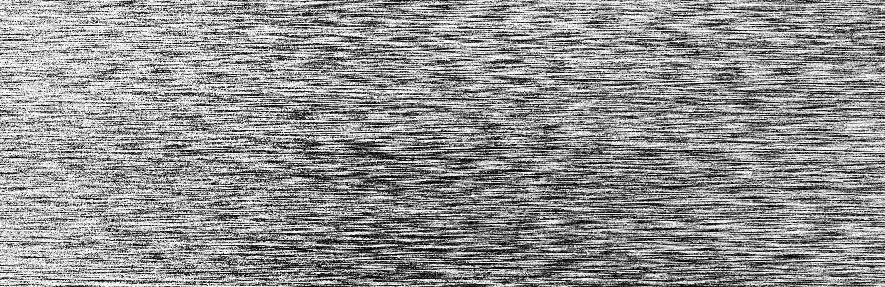 Metal texture with white scratches. Abstract noise black background overlay for design. photo