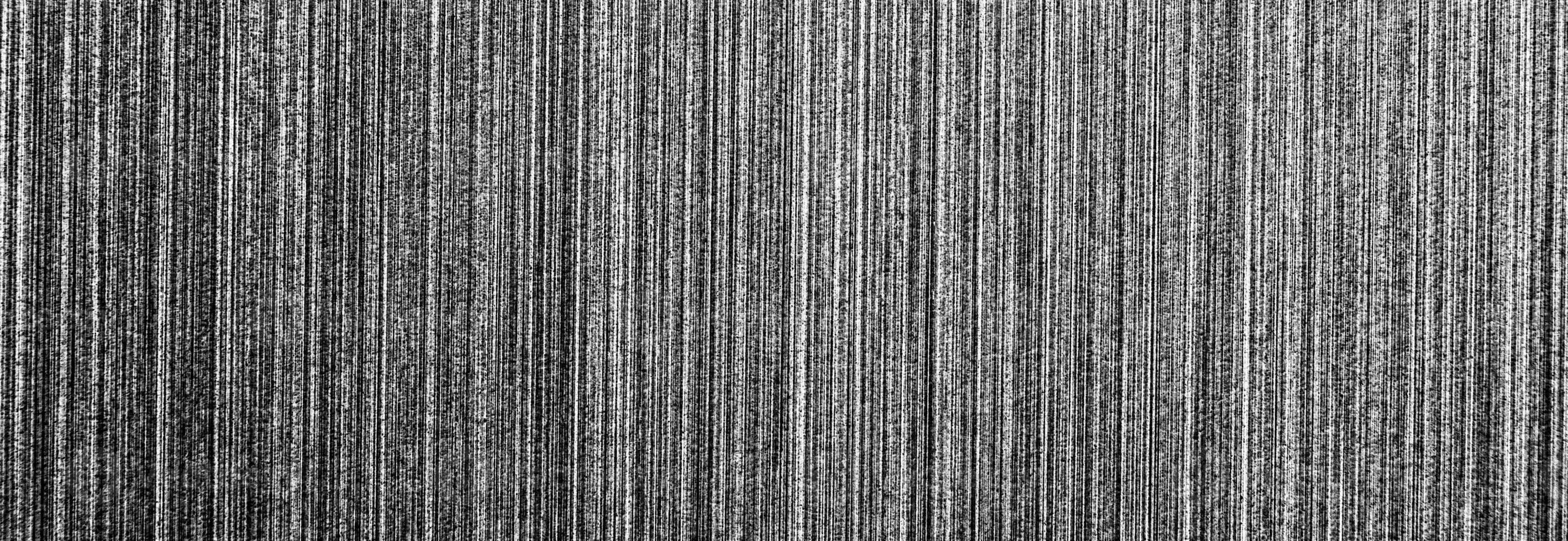 Metal texture with white scratches. Abstract noise black background overlay for design. photo
