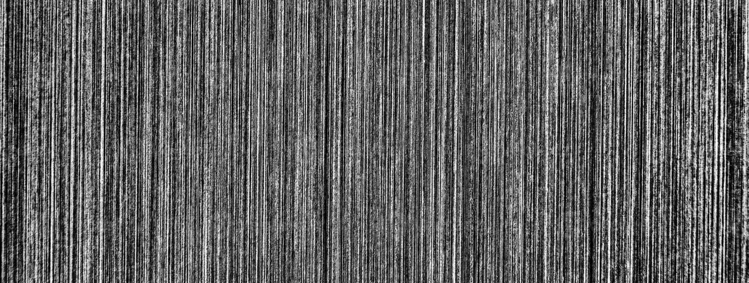 Metal texture with white scratches. Abstract noise black background overlay for design. photo