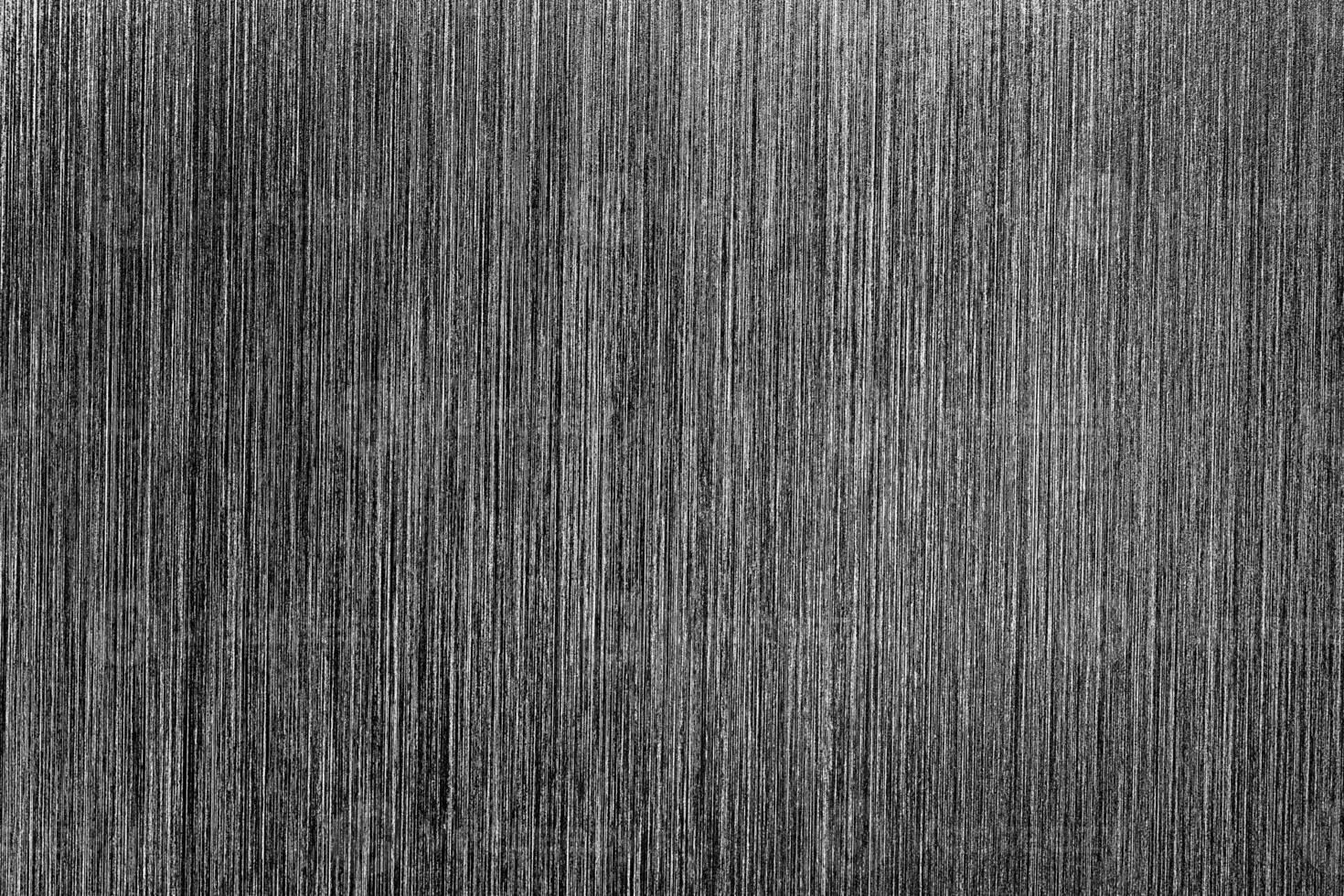Metal texture with white scratches. Abstract noise black background overlay for design. photo