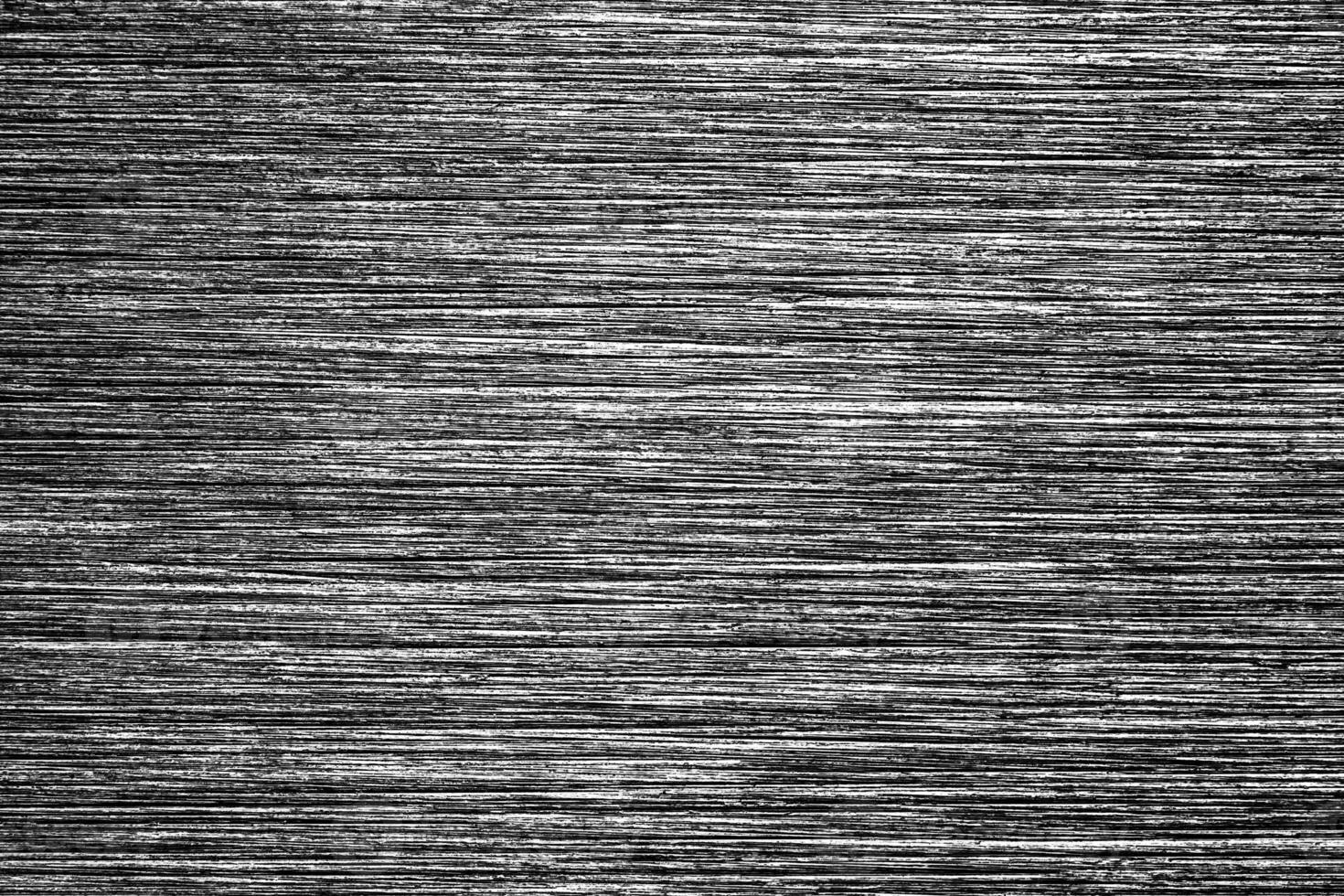 Metal texture with white scratches. Abstract noise black background overlay for design. photo