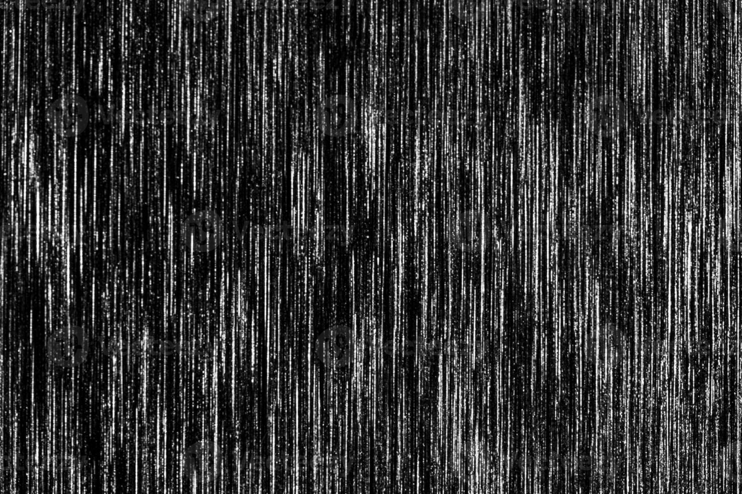 Black metal texture with white scratches. Abstract noise black background overlay for design. photo