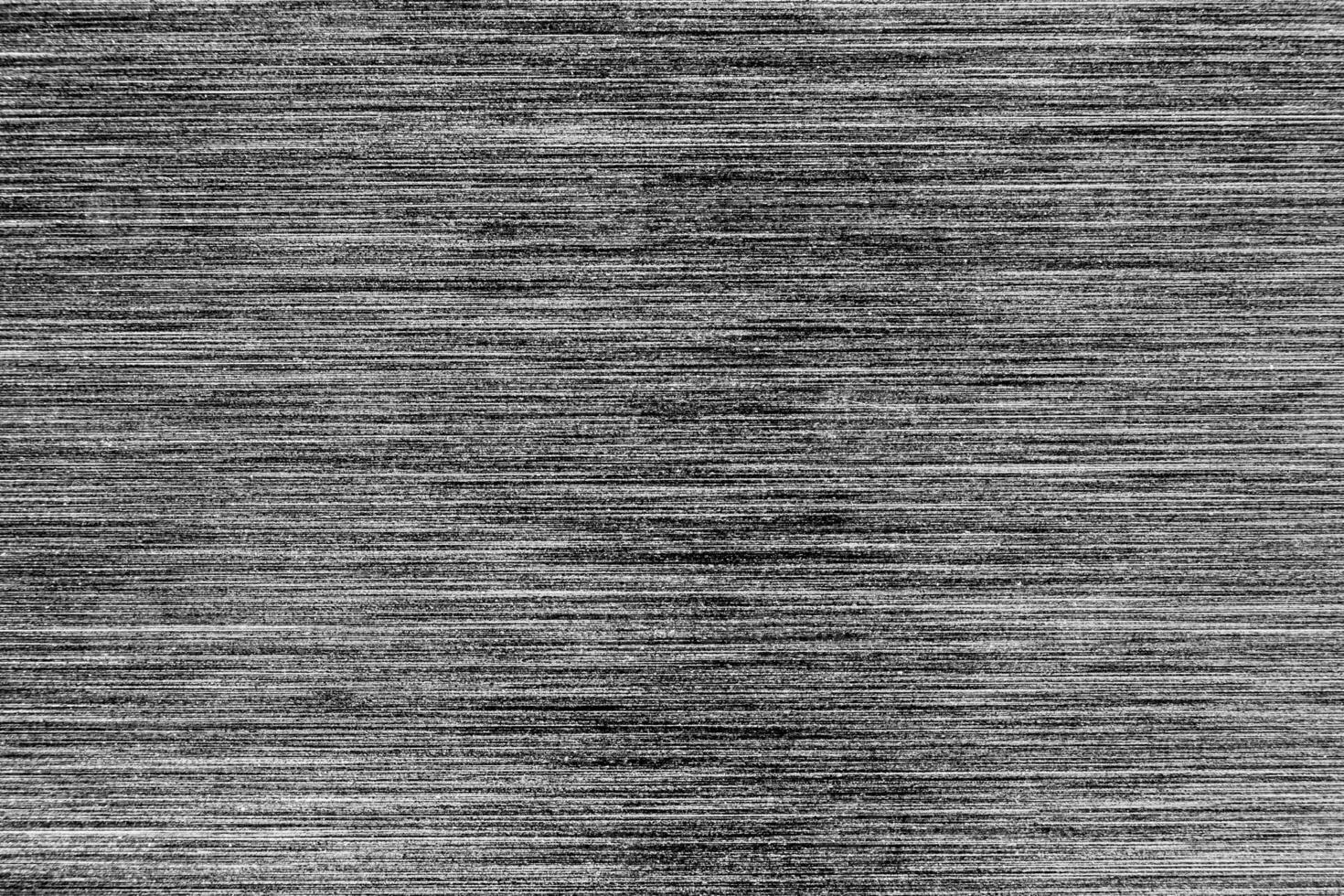 Silver metal texture with white scratches. Abstract noise black background overlay for design. photo