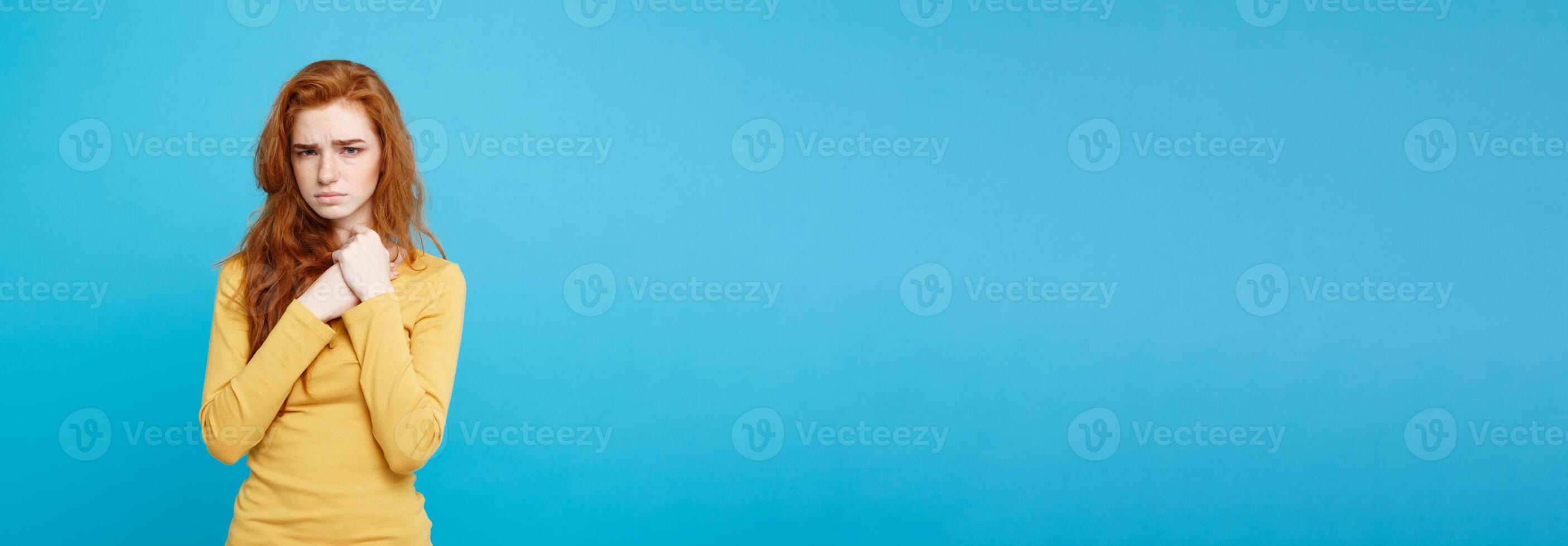Healthcare Concept - Portrait of young beautiful ginger woman feeling sick and stressful. Isolated on pastel blue background. Copy space. photo