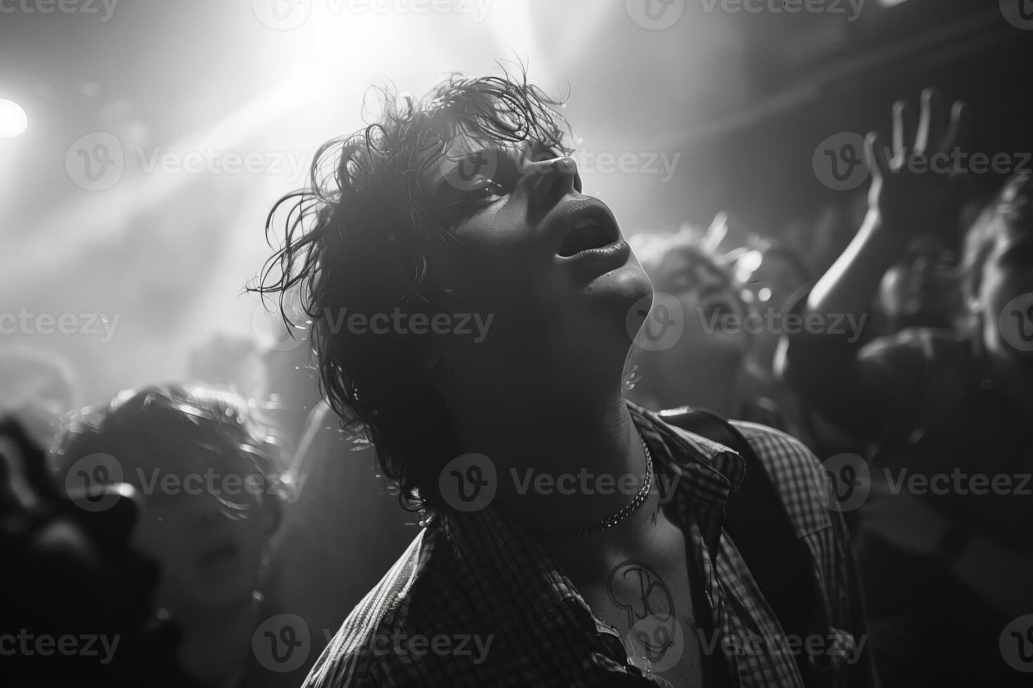 A black and white photograph showing a man in a crowd under the sky photo