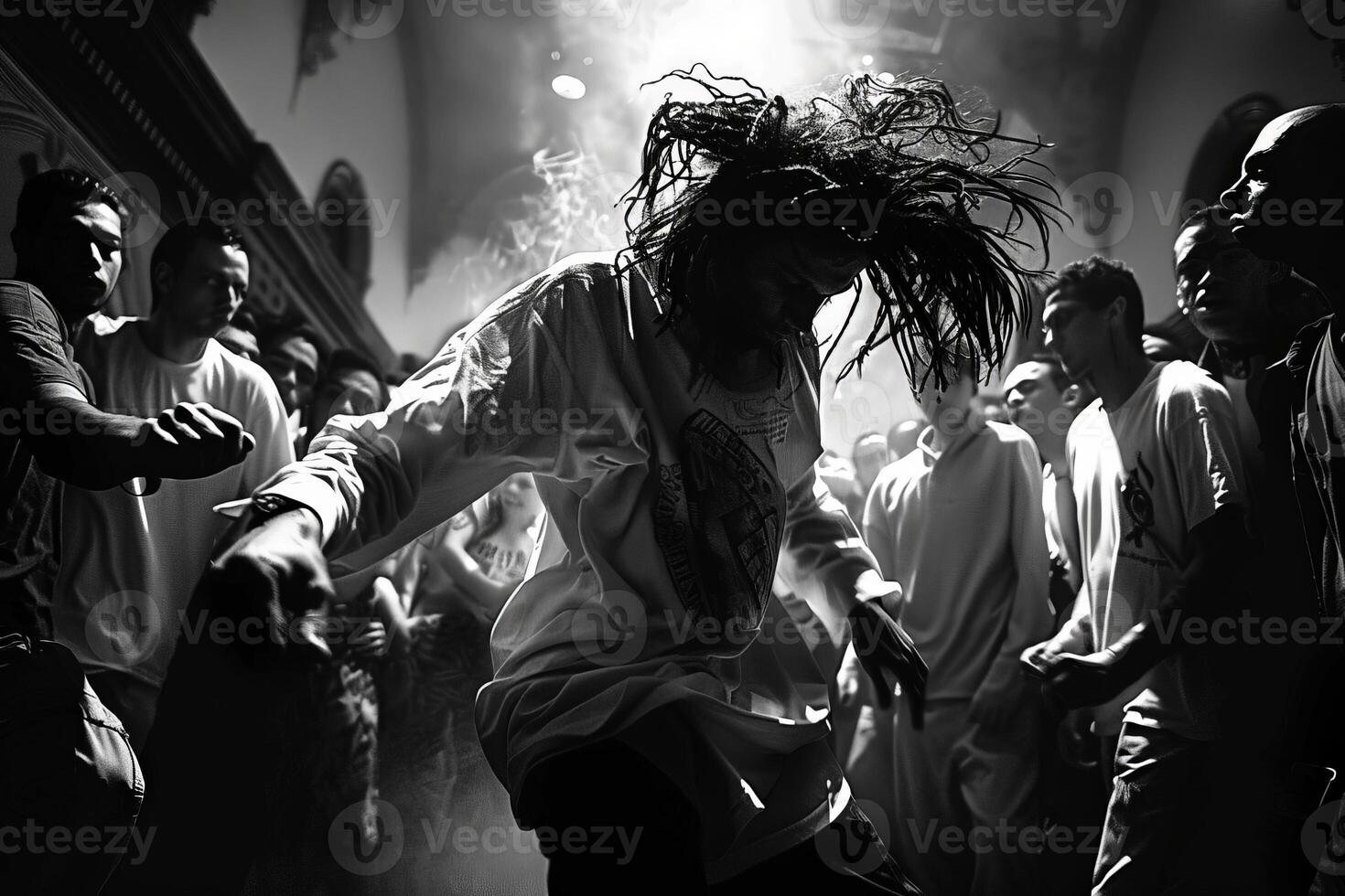 A photo depicting a man dancing in a crowd, captured in black and white