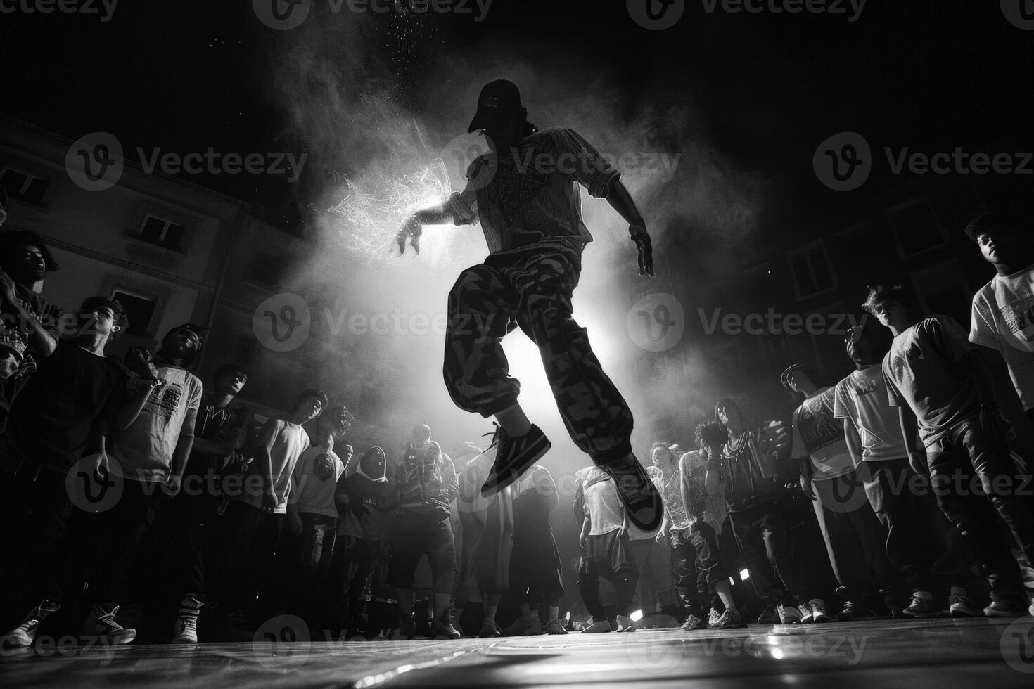 A man is demonstrating his jumping skills in front of an audience photo