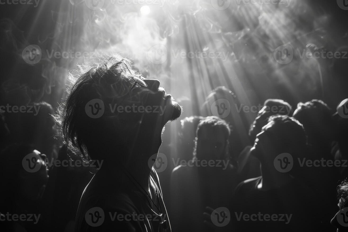 A monochrome photo showing a group of people gazing upwards