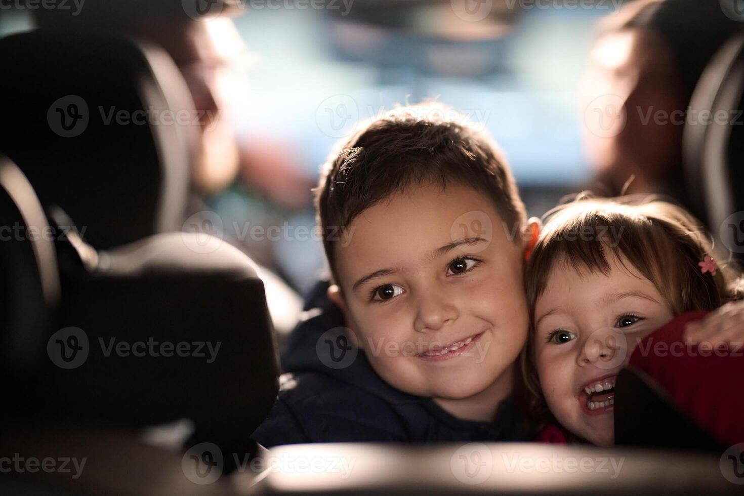 A young brother and sister enjoying a car ride together, immersed in the adventure of travel photo