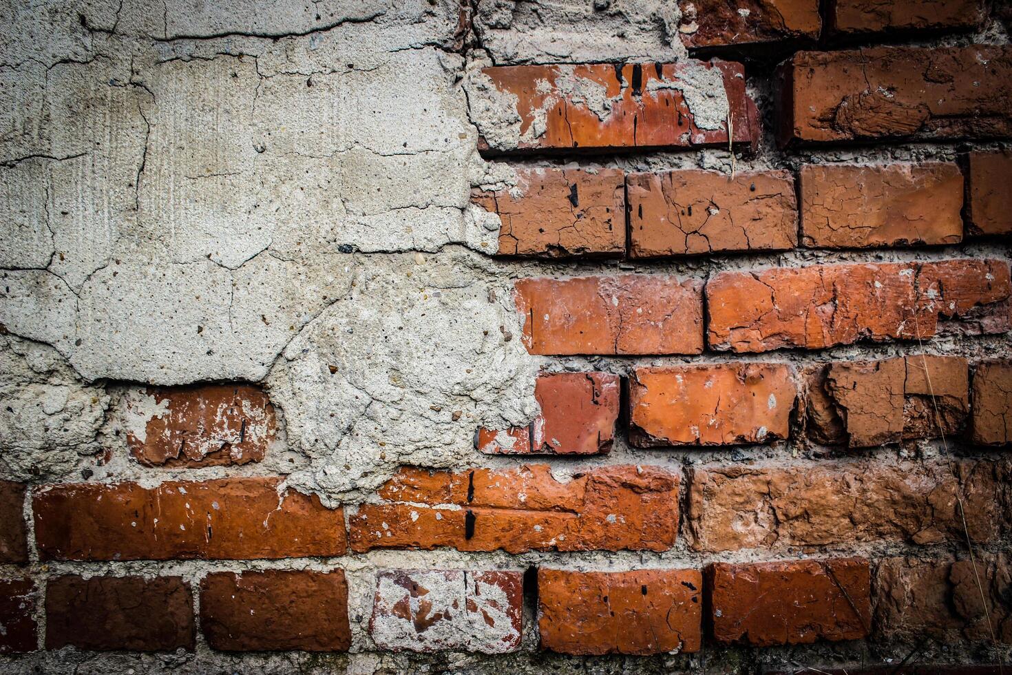 the texture of an old brickwork with fragments of plaster photo