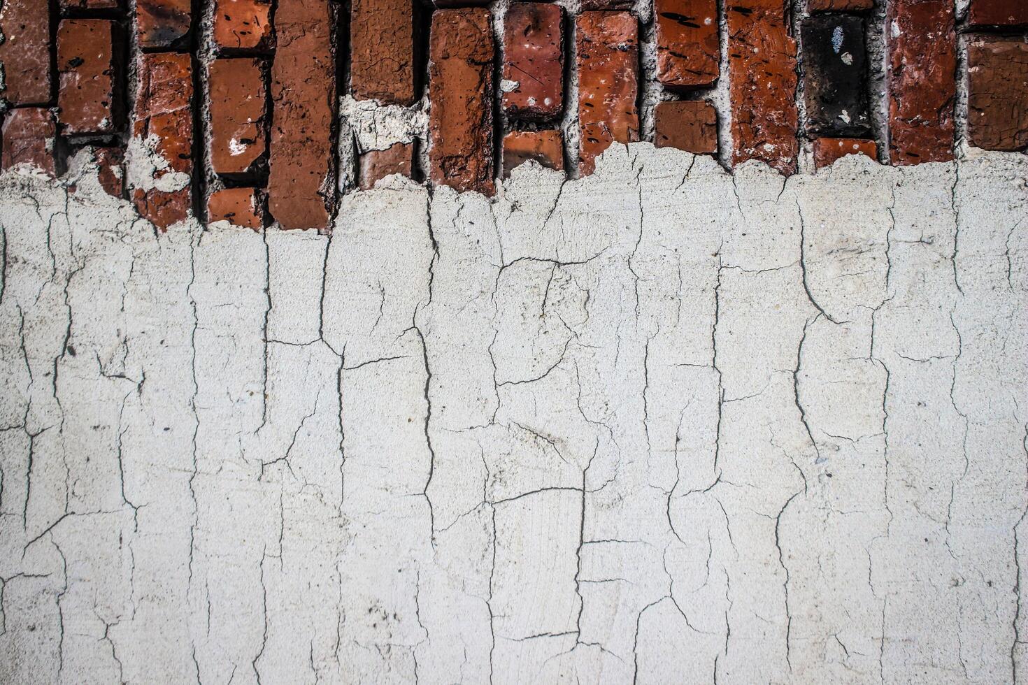 the texture of an old brickwork with fragments of white plaster photo