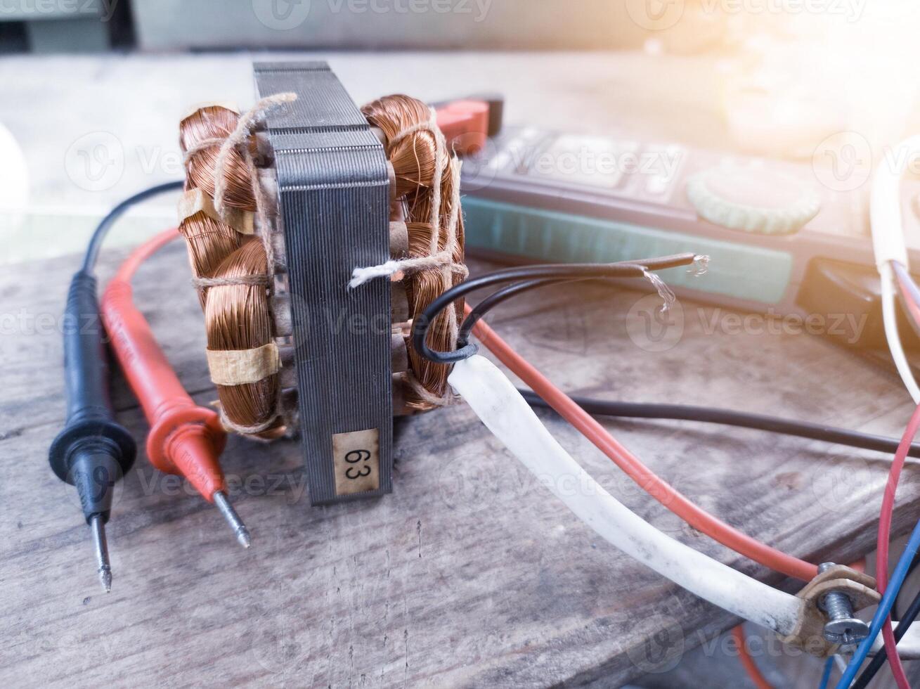 Fan motor winding repair process, concept of checking and repairing motor windings using a tester. photo