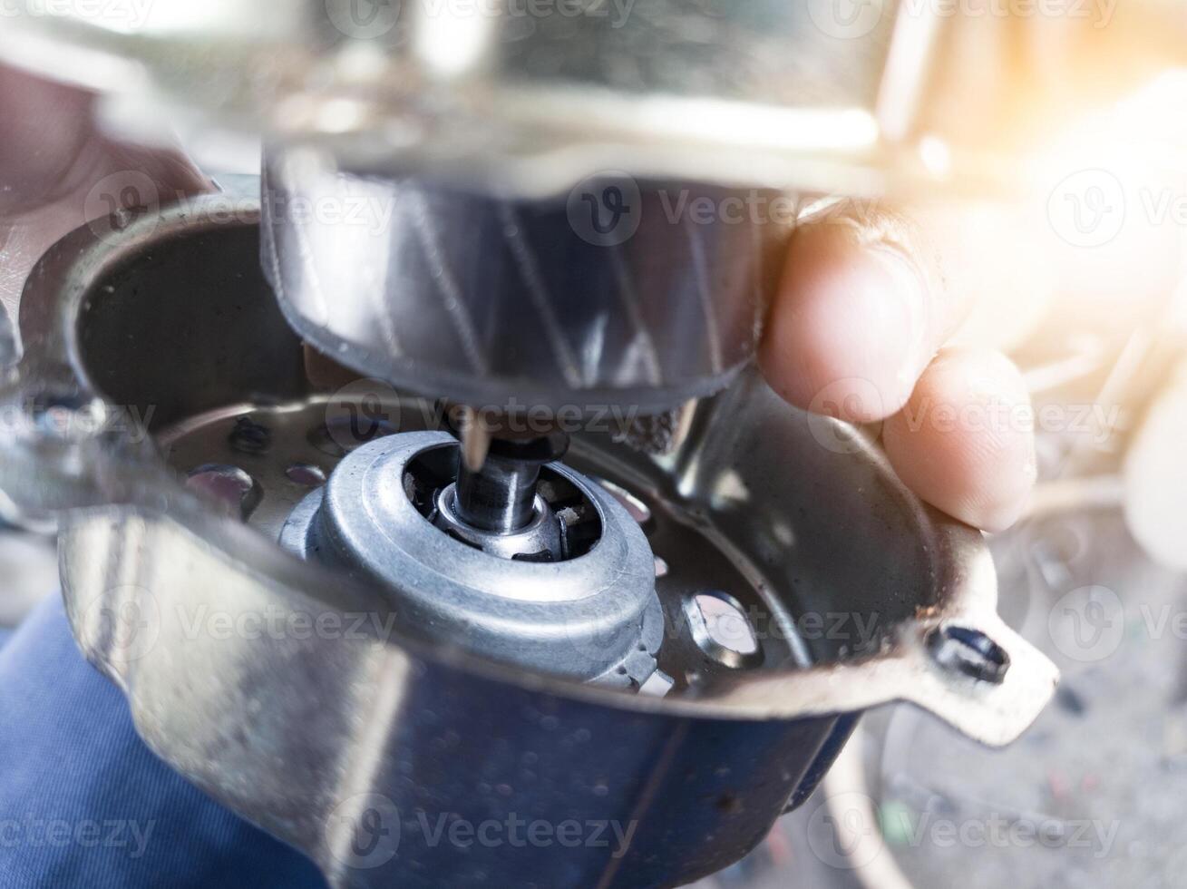 Checking the rotor on the cooling fan winding housing. photo