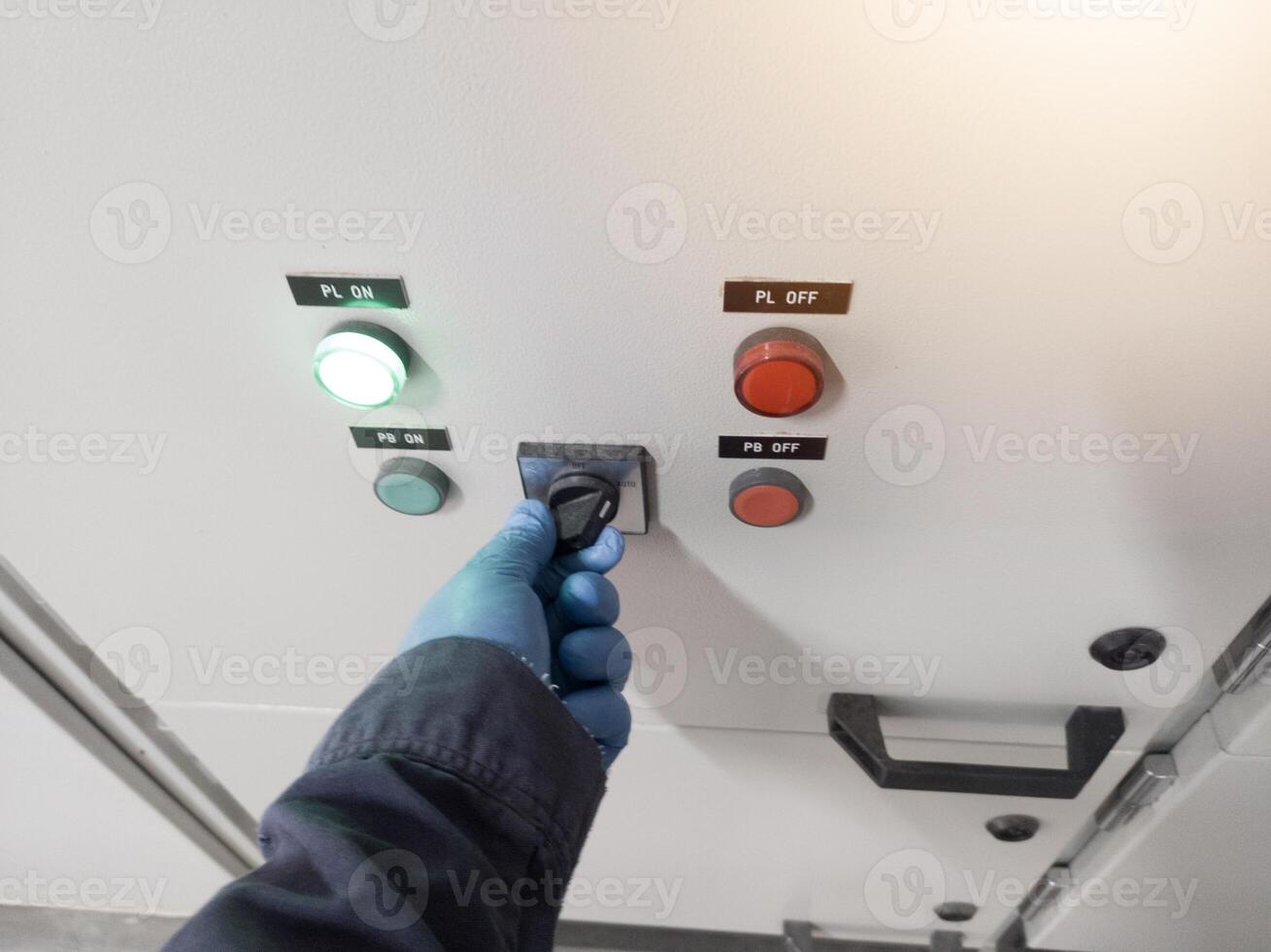 The hand engineer controll of switching on the panel power house in industry, electrical panel conceptual. photo