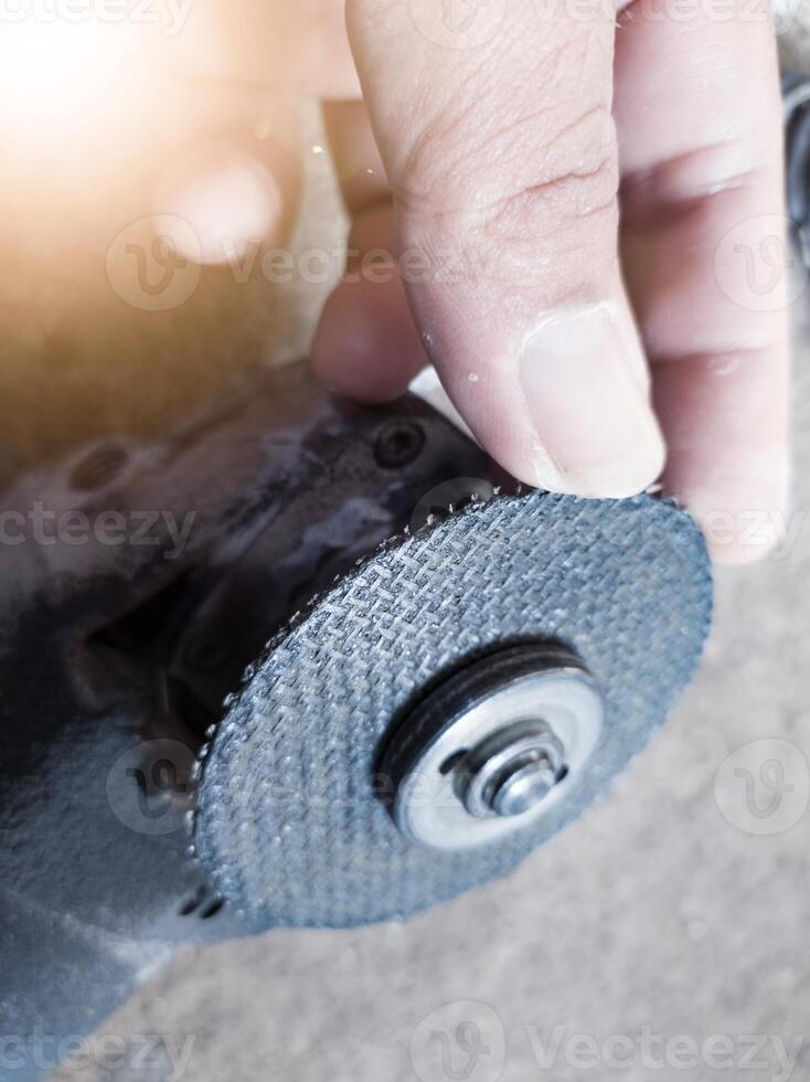 Checking the condition of the cutting grinding wheel by a technician. photo