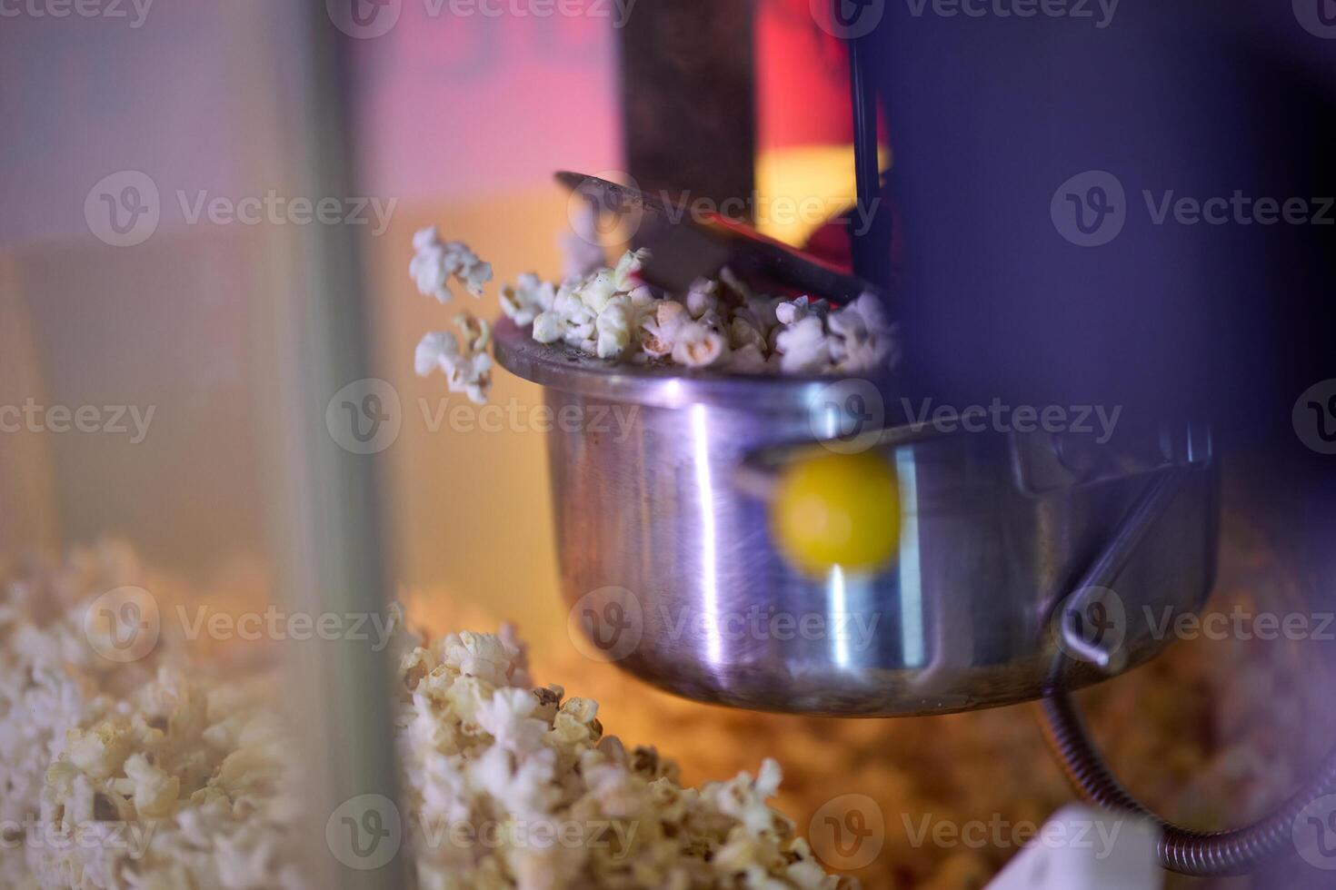 A vendor stands outside the cinema, holding freshly popped popcorn to sell to moviegoers before they enter the theater photo