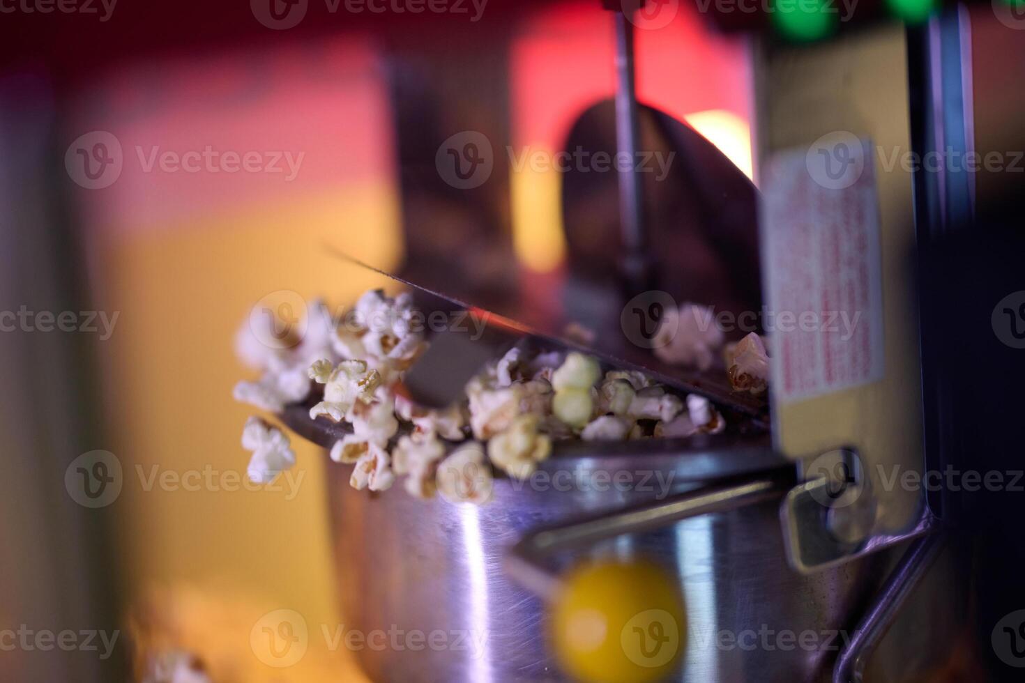 A close-up shot captures the mesmerizing process of making cinema popcorn, with kernels popping and releasing an irresistible aroma, promising a delightful snack for moviegoers photo