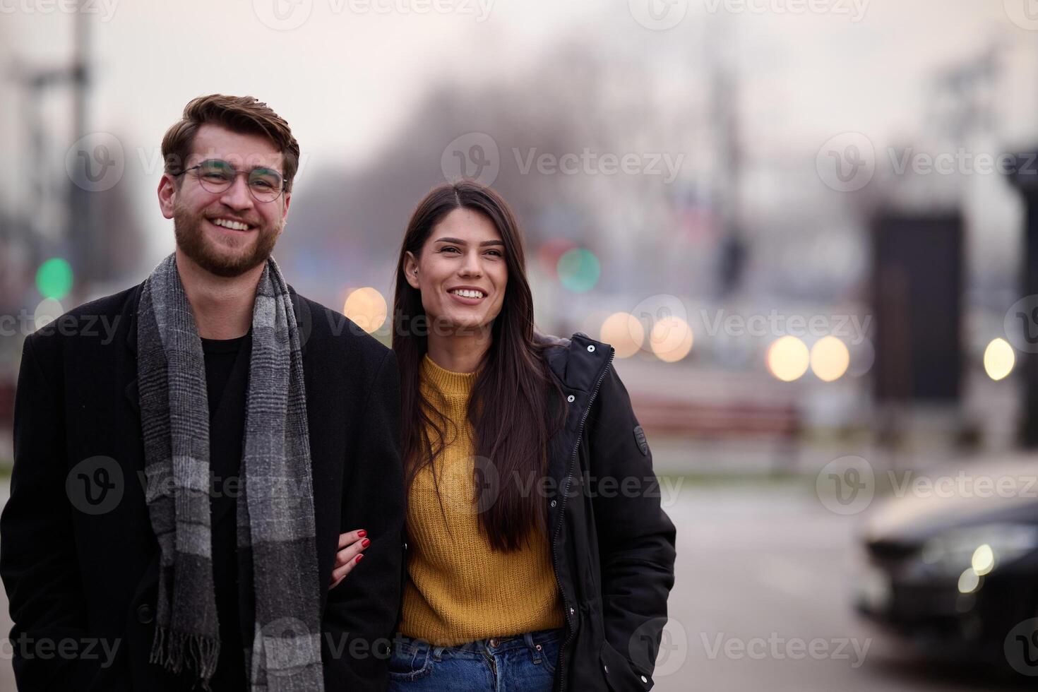 A romantic couple embraces in a tender hug as they stroll through the city streets, enjoying leisure time together in each other's company photo