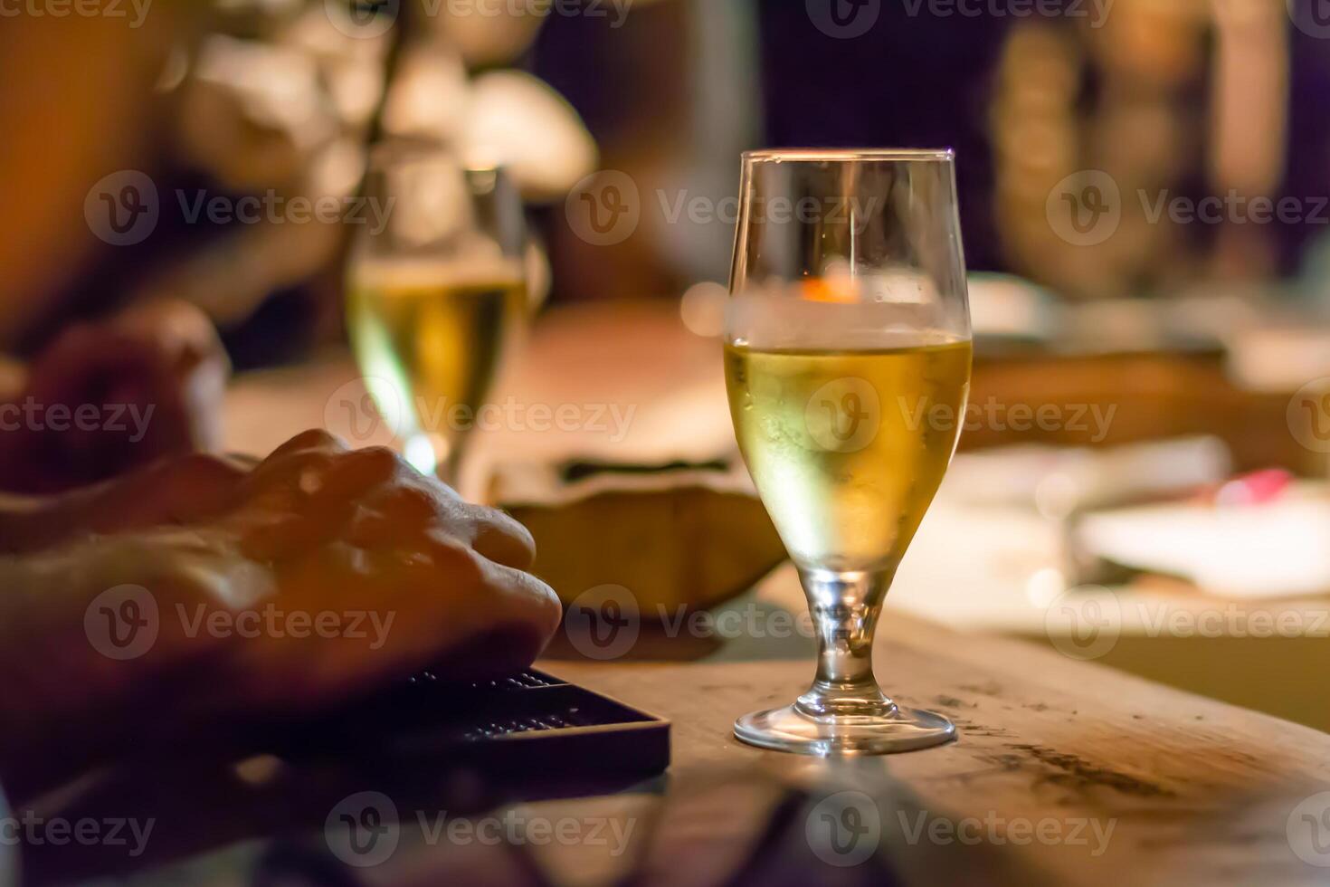 Glass of white wine on rustic bar counter photo