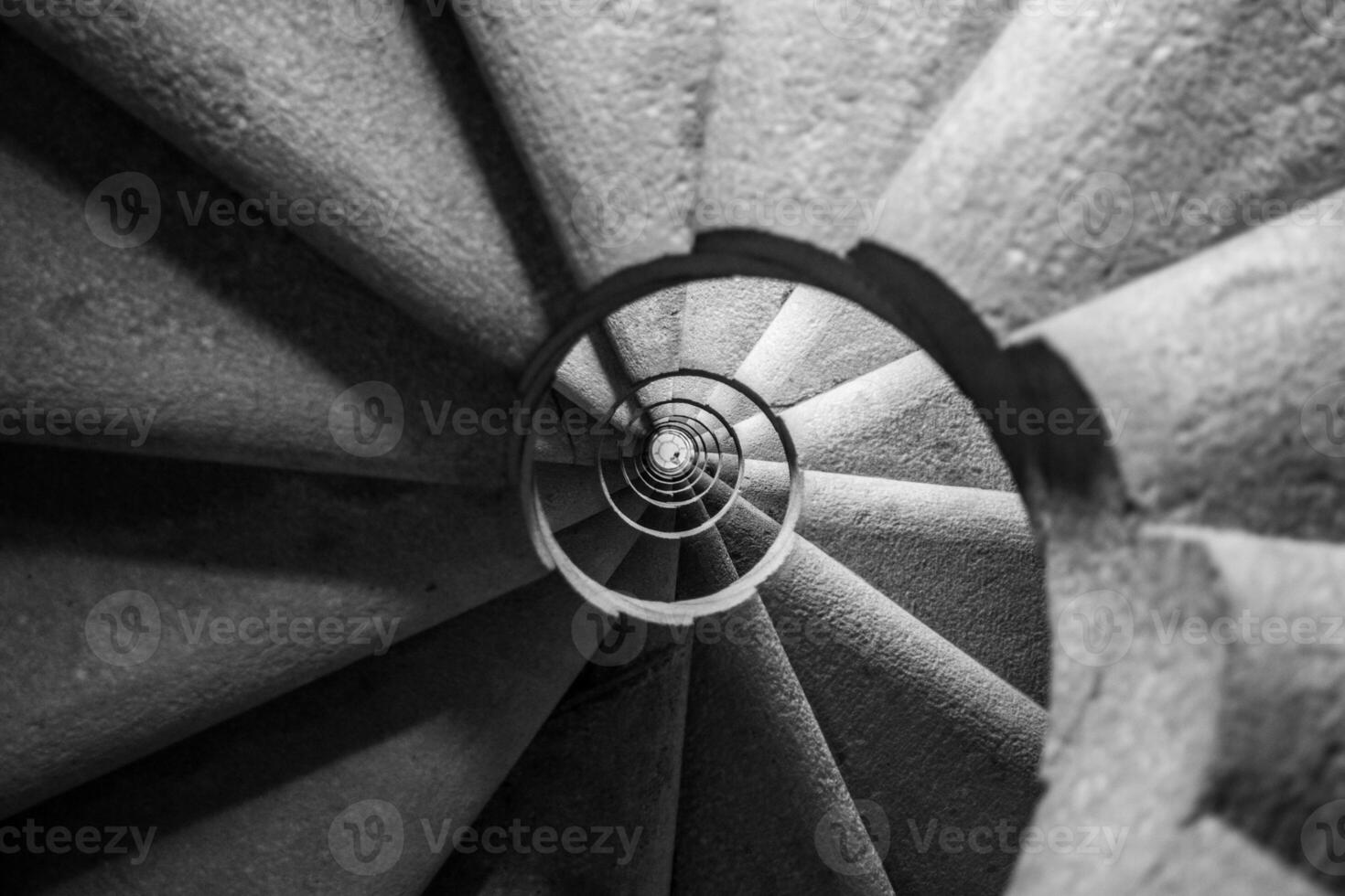Winding and spiralling concrete staircase in a tower, with infinity point photo