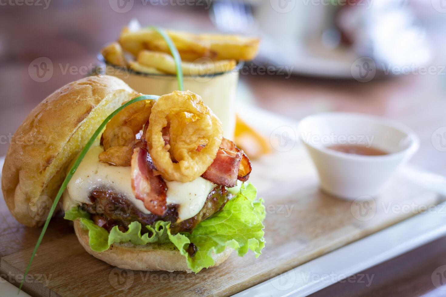 Tasty and delicious beef hamburger, with calamares, salad, bacon and egg and french fries. photo