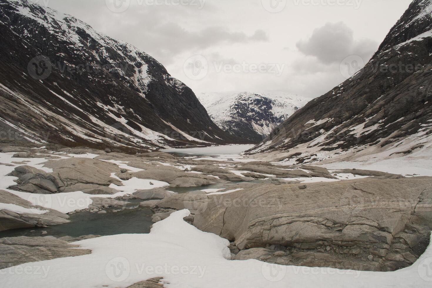 Glacier landscape with ice and rocks in Norway, illustrating retreating ice due to climate change. photo