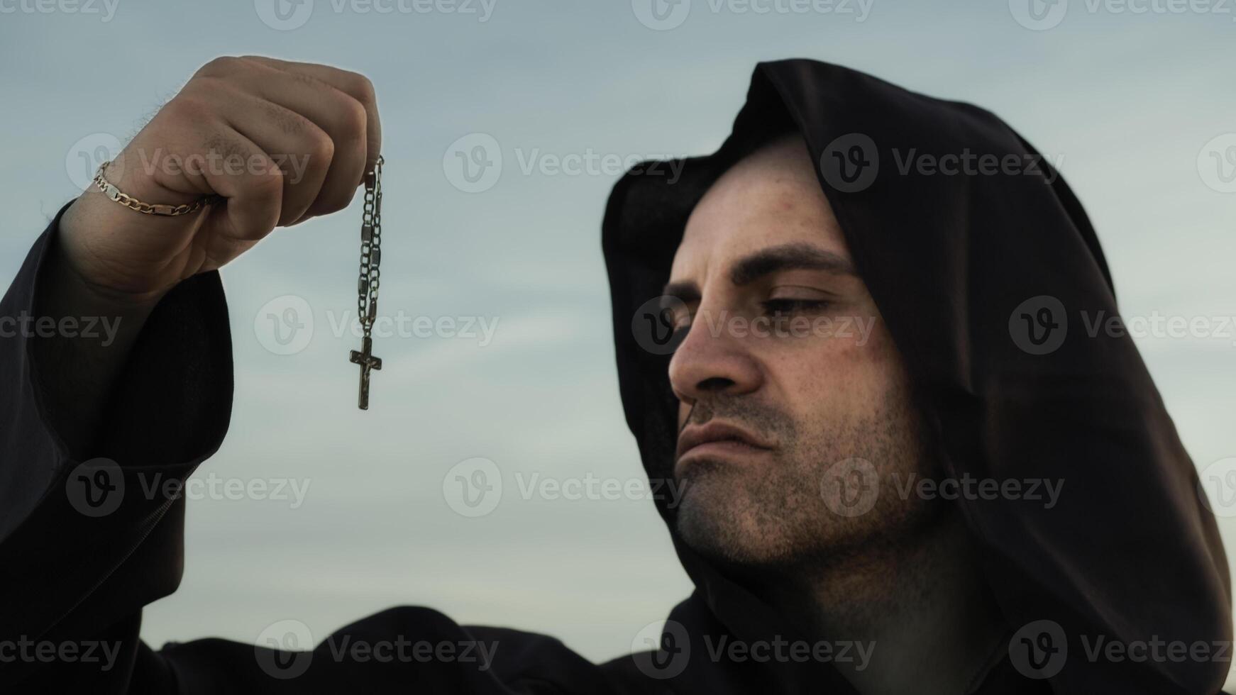 Religious Monk Kisses The Crucifix Jesus In Symbol Of Faith photo