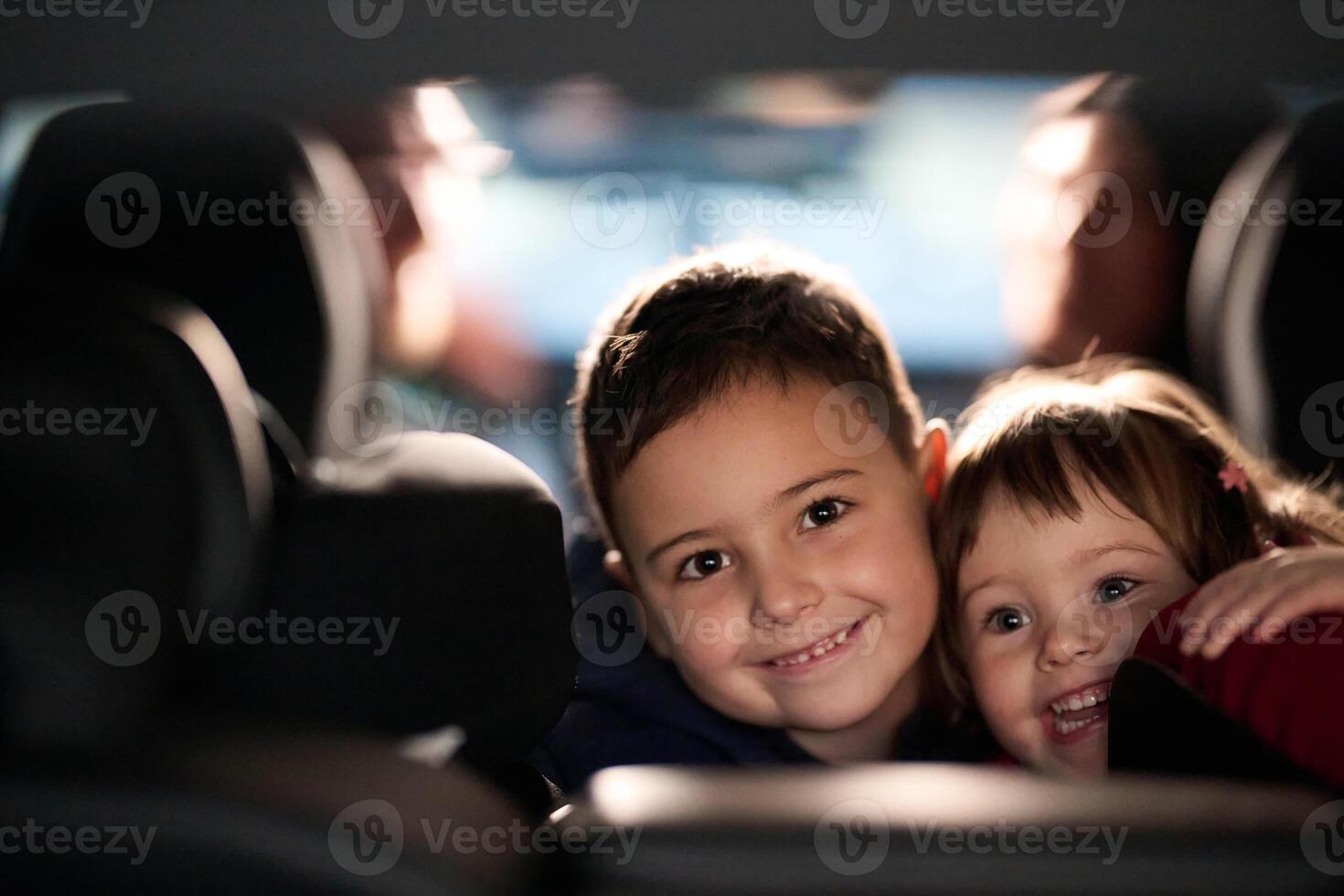 A young brother and sister enjoying a car ride together, immersed in the adventure of travel photo
