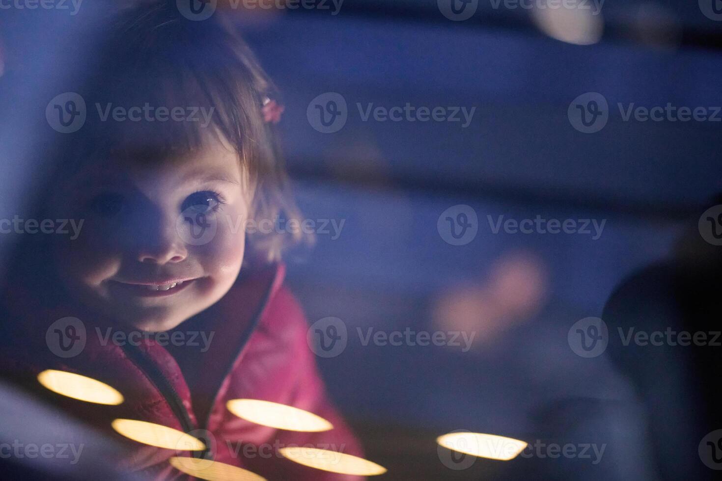 A young girl sits comfortably in a modern car seat, secured and ready for a family adventure on the road. photo
