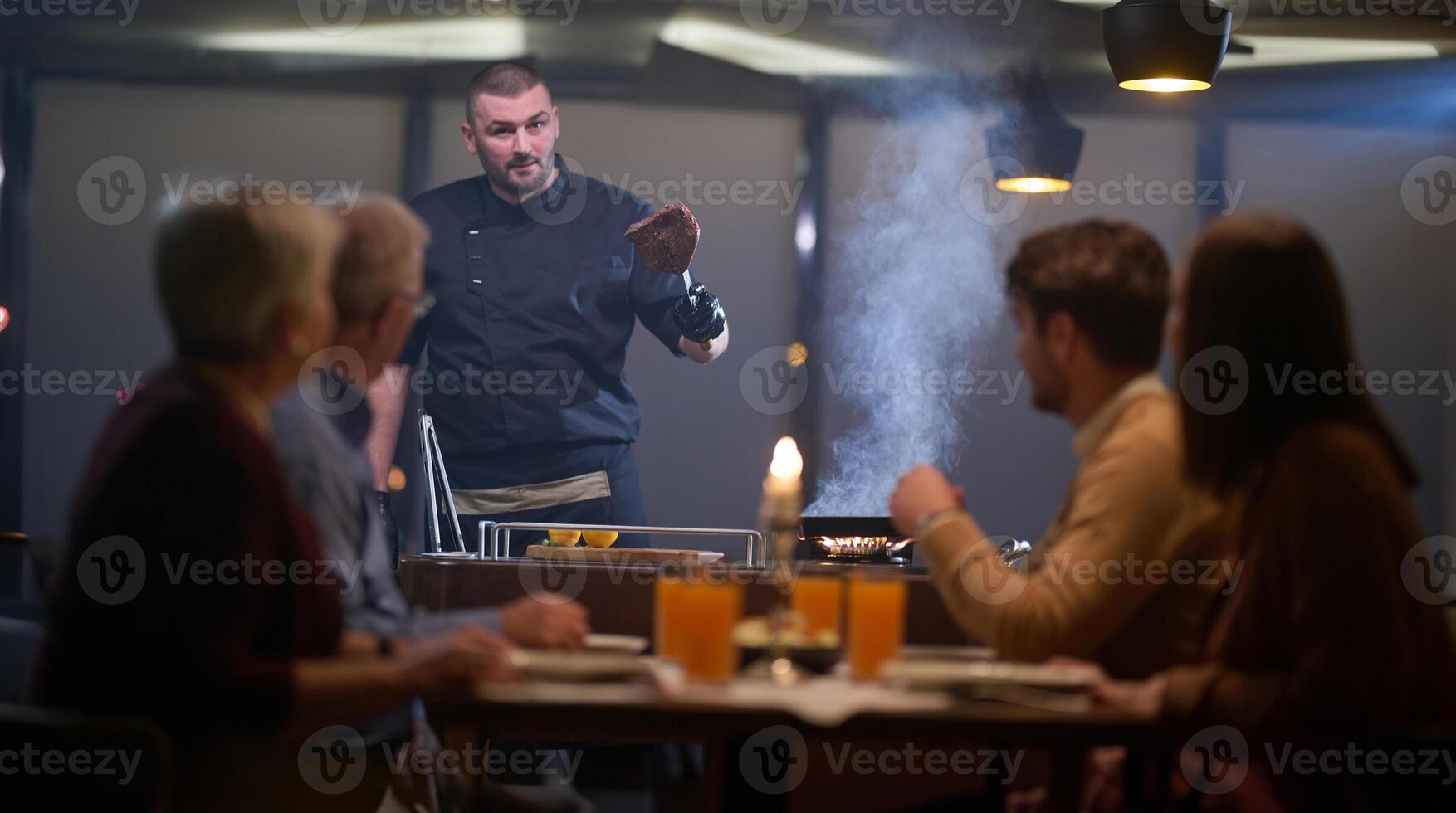 In a restaurant setting, a professional chef presents a sizzling steak cooked over an open flame, while an European Muslim family eagerly awaits their iftar meal during the holy month of Ramadan photo