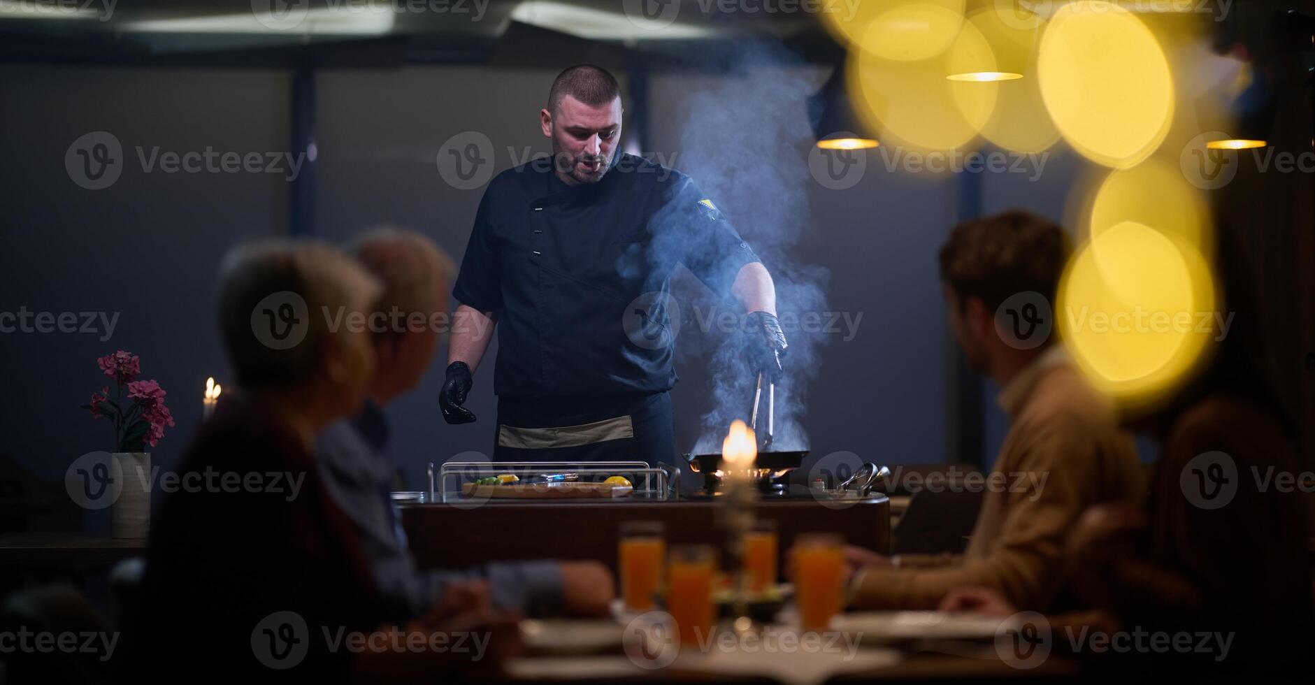 In a restaurant setting, a professional chef presents a sizzling steak cooked over an open flame, while an European Muslim family eagerly awaits their iftar meal during the holy month of Ramadan photo