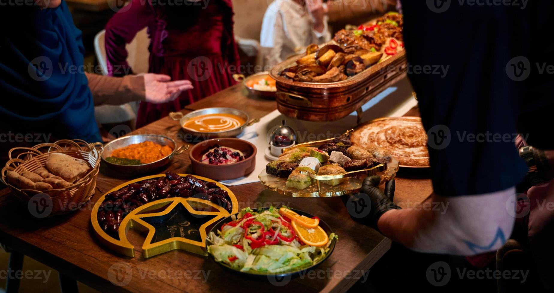 In this captivating aerial view, delicious food adorned with Ramadan decorations, including dates and meat, awaits the arrival of an European Islamic family, promising a festive and flavorful iftar photo